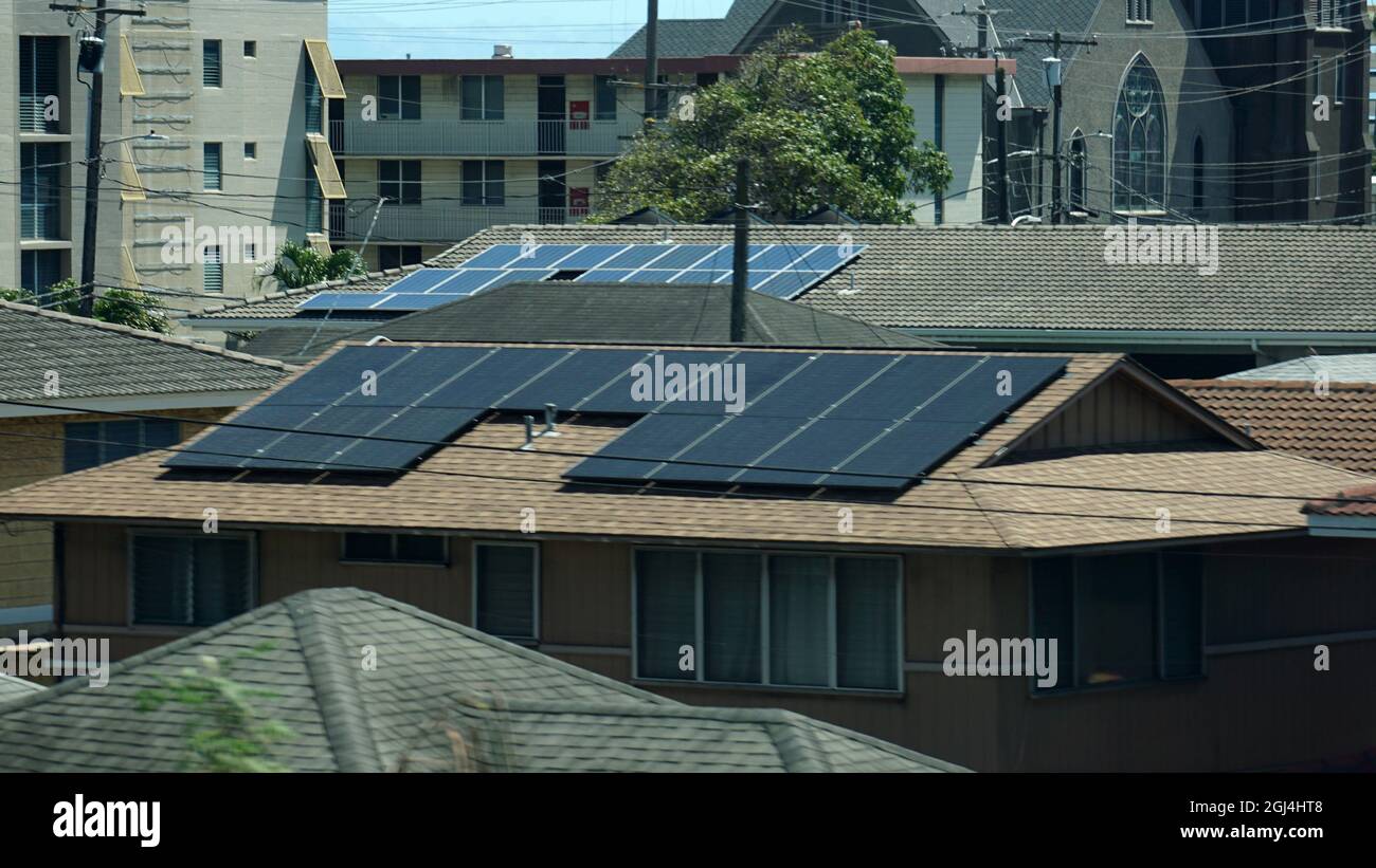 Rooftop solar panels on a house in Hawaii help offset electricity costs