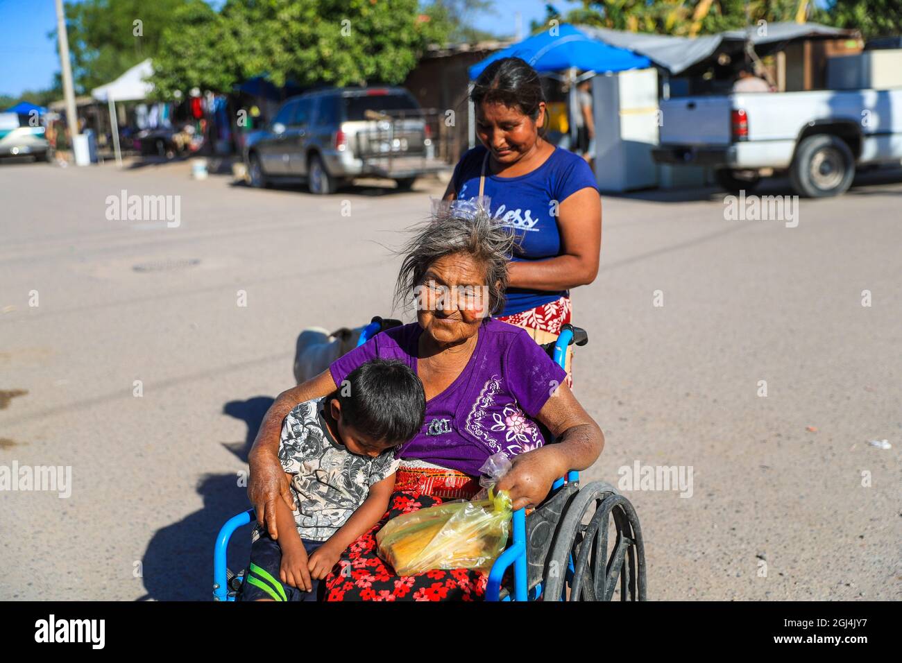 An elderly woman in a wheelchair. Daily life in the extreme poverty  community with a floating population of day laborers in the Miguel Aleman  or Calle town on the coast of Hermosillo. (