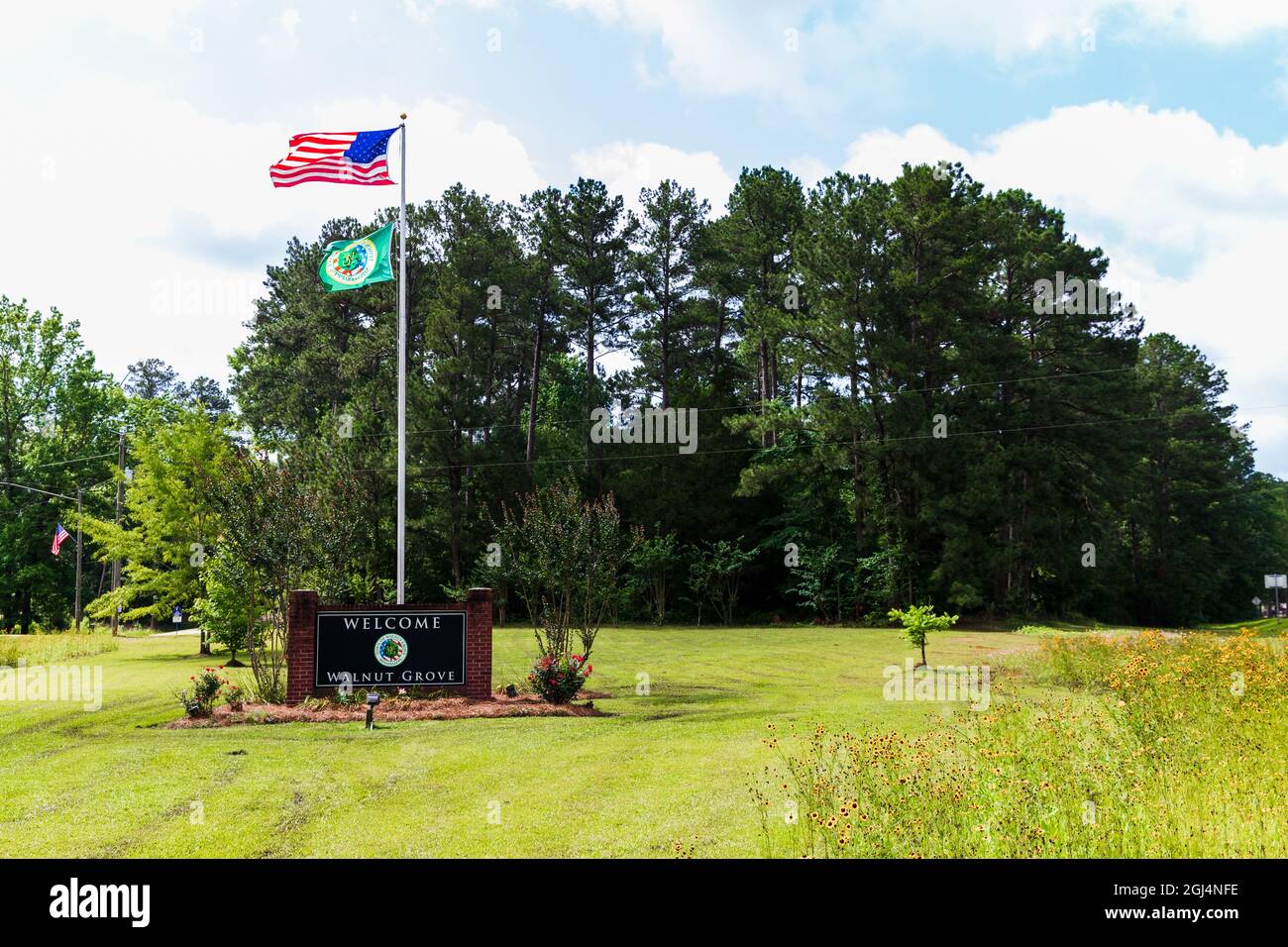 Walnut Grove, MS - June 9, 2021: Welcome to Walnut Grove sign and flags Stock Photo