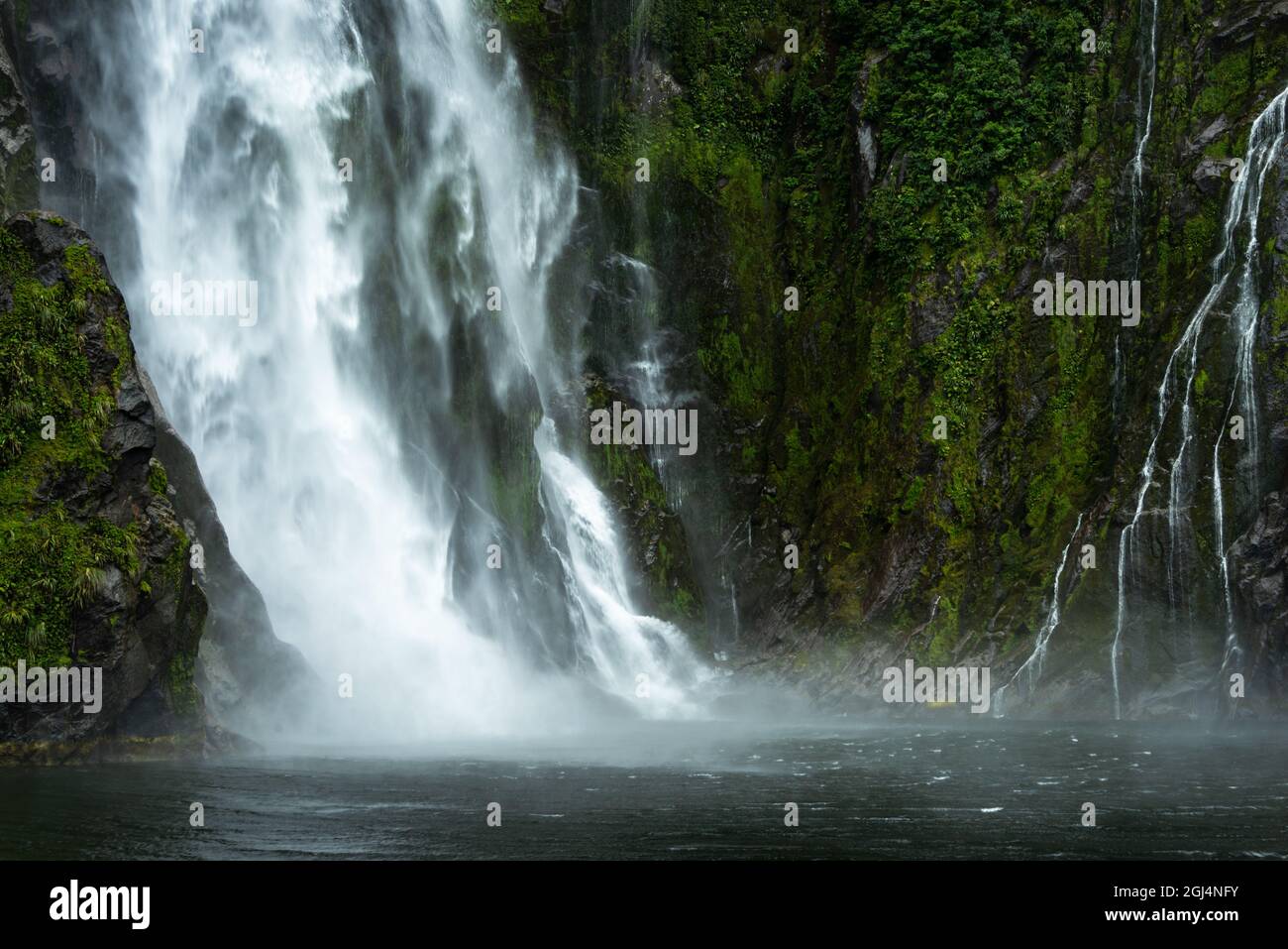 A small waterfalls alongside Stirling Falls in Milford Sound, South Island, New Zealand Stock Photo