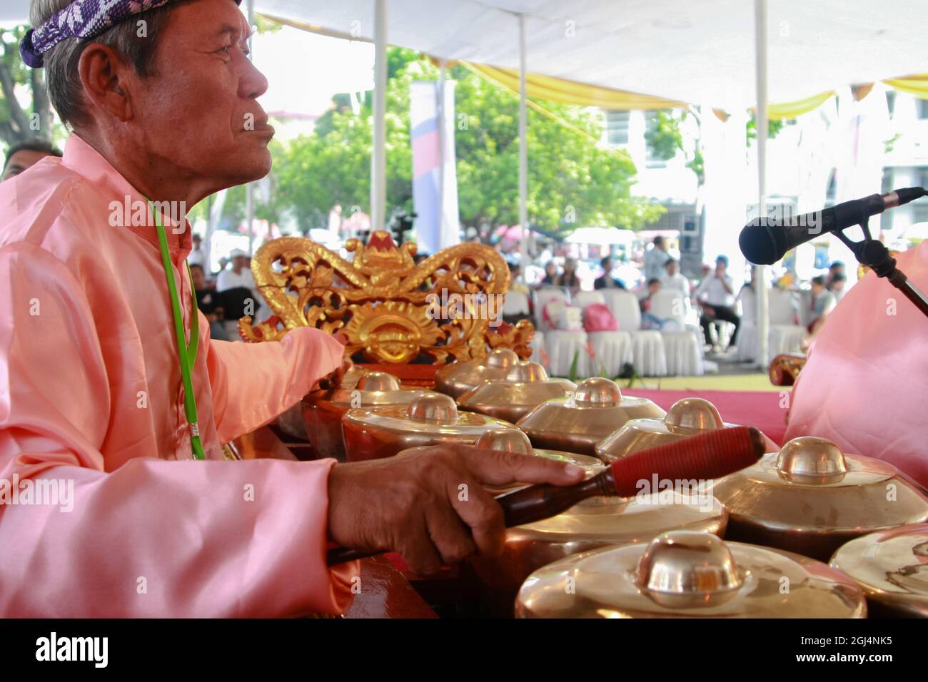 A bonang musician, one of the gamelan musical instruments, is accompanying a Palembang shadow puppet show or wayang kulit Palembang. Stock Photo