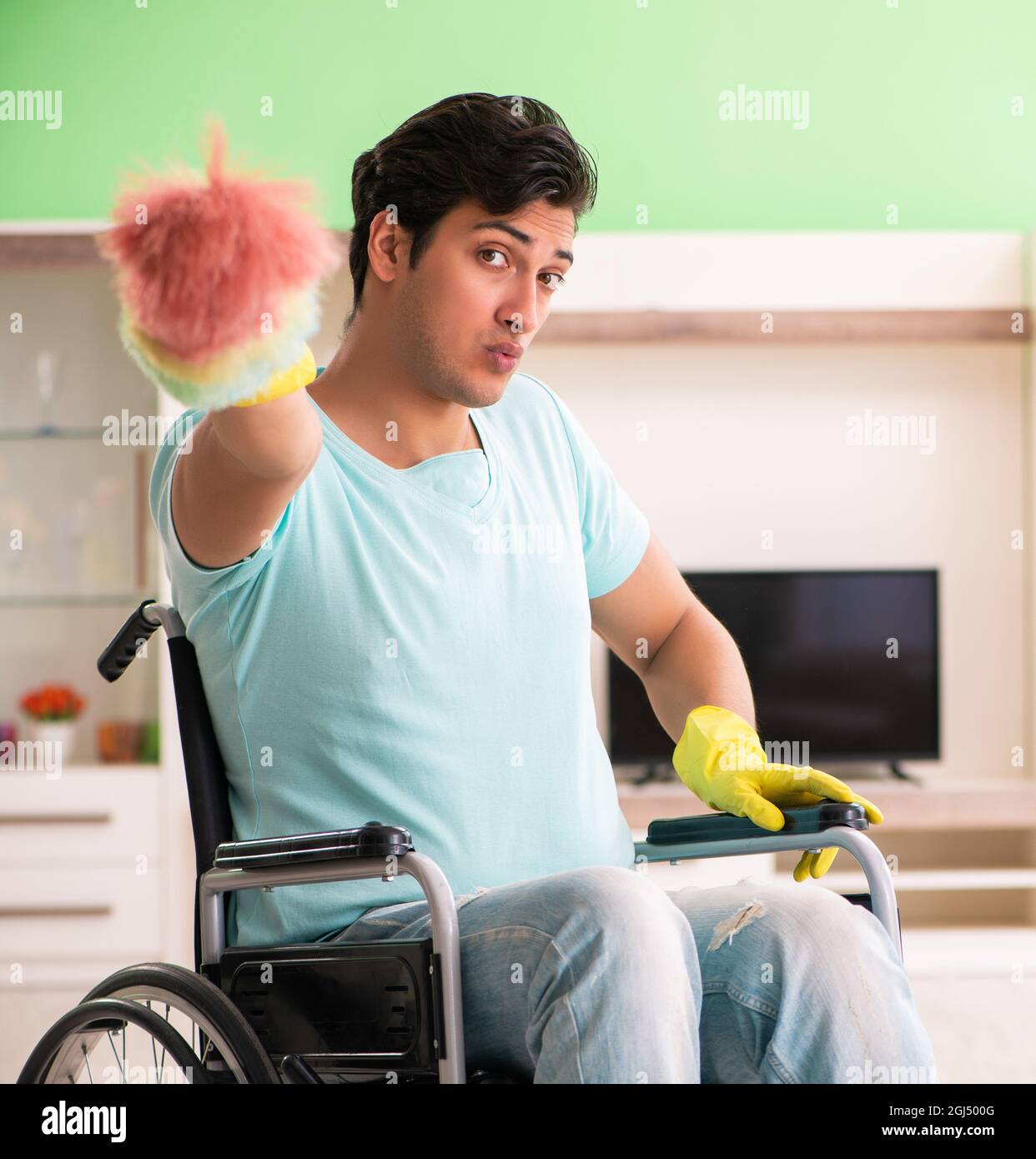 The disabled man on wheelchair cleaning house Stock Photo Alamy