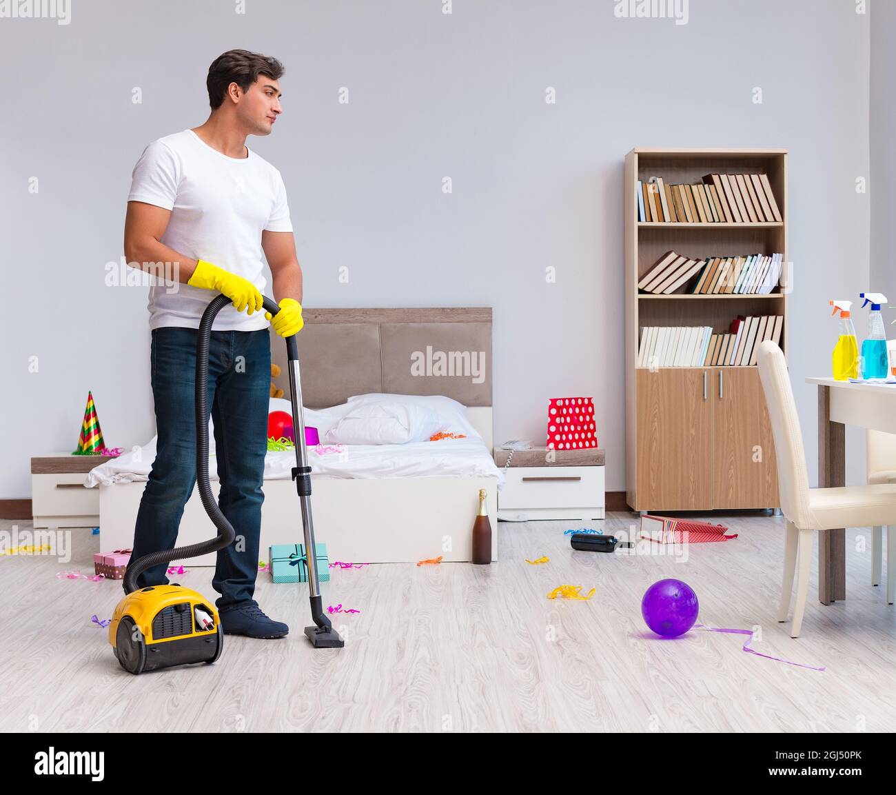 The man cleaning the house after christmas party Stock Photo - Alamy
