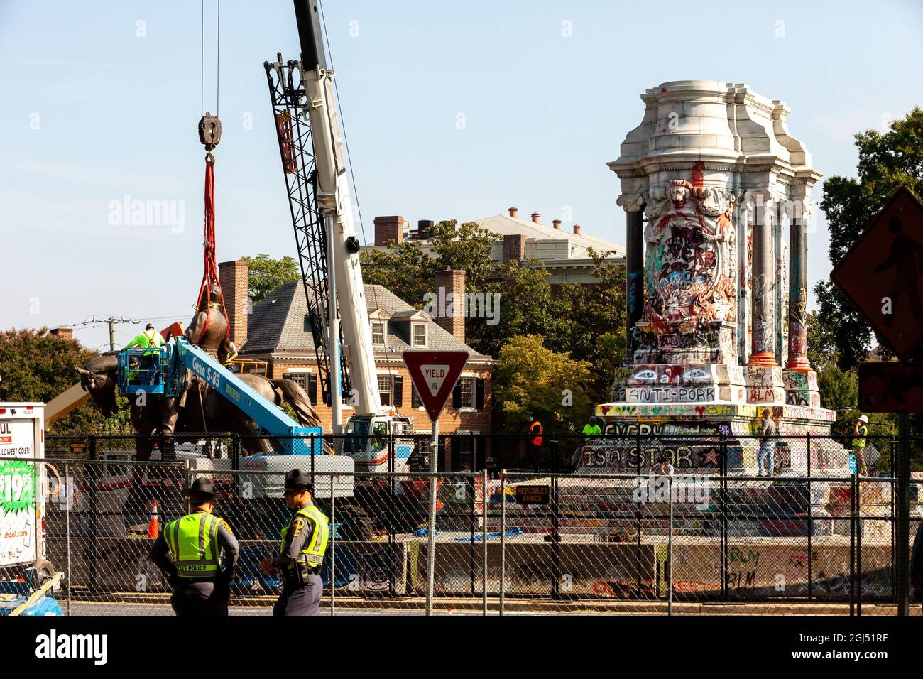 Richmond, VA, USA, 8 September, 2021.  Pictured: State troopers watch as workers saw the statue of Confederate general Robert E. Lee into two pieces for transport following its removal.  The Virginia supreme court ruled last week that the six-story monument could be removed.  It has yet to be determined whether the pedestal covered in anti-racism graffiti will be removed given its prominent role in the 2020 anti-racism uprising in Richmond.  Credit: Allison Bailey / Alamy Live News Stock Photo