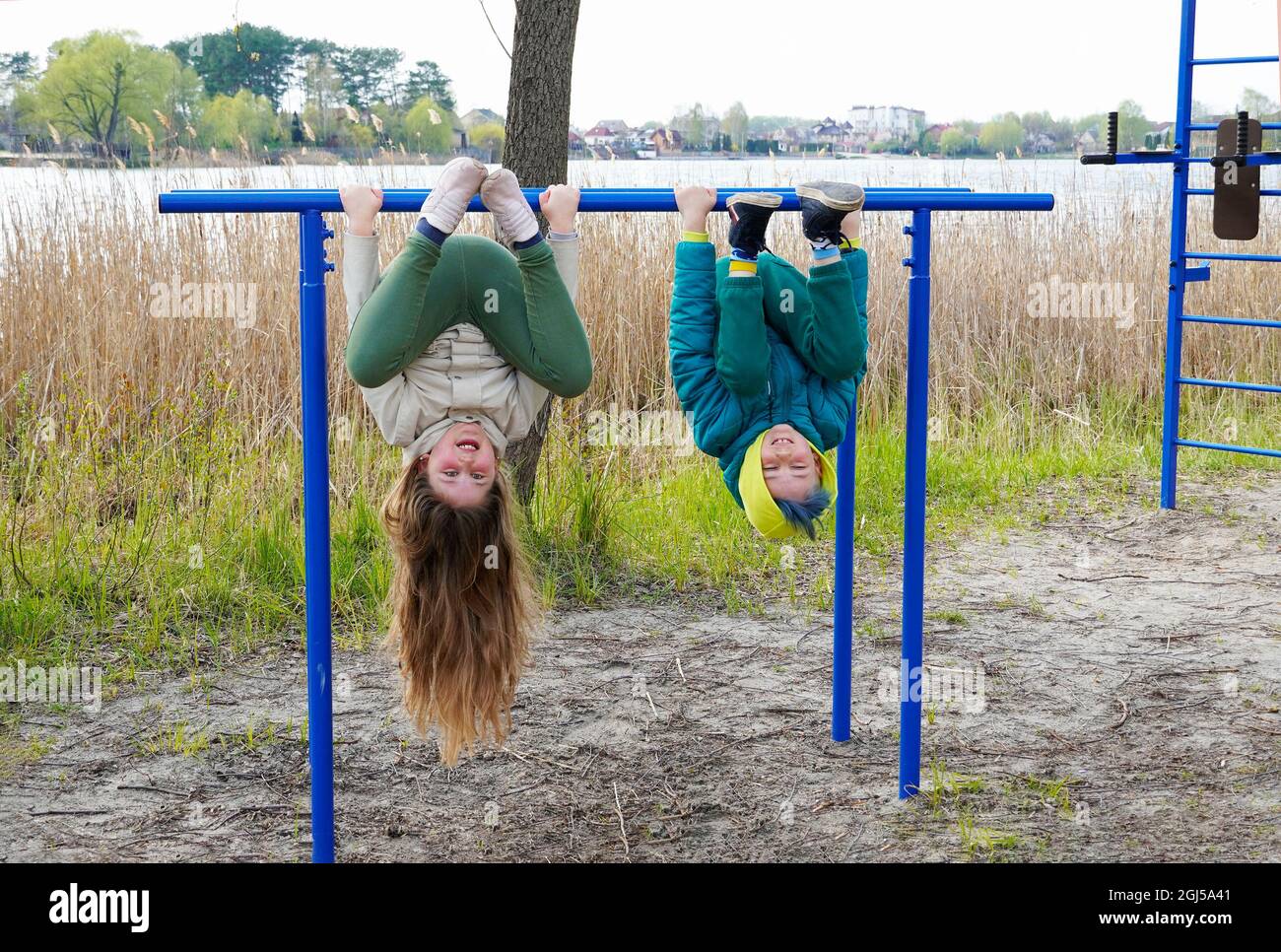 Two young children sibling having fun on the sport playground. Stock Photo