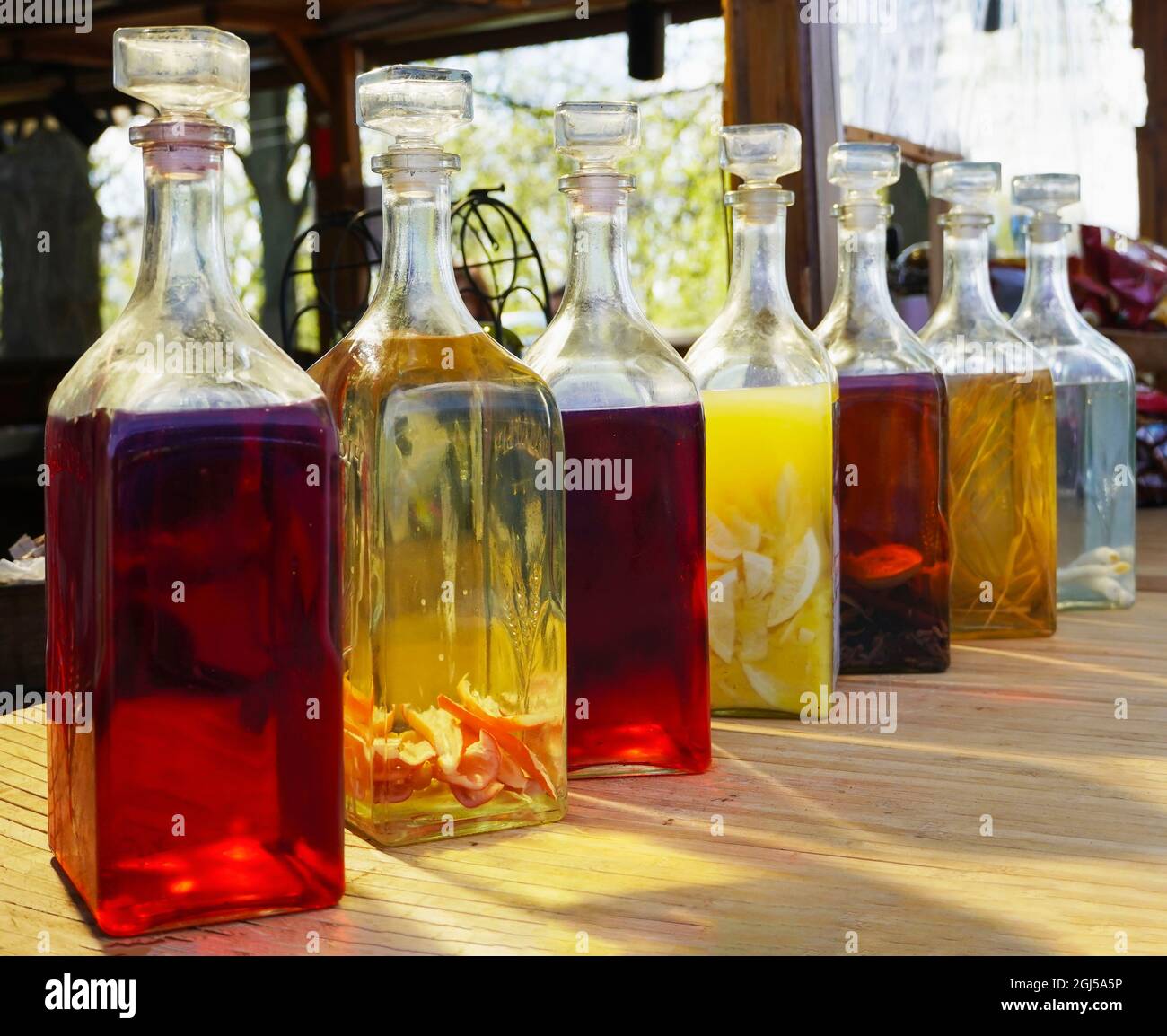 Homemade liqueur witn fruits in glass bottle. Set of Homemade alcohol