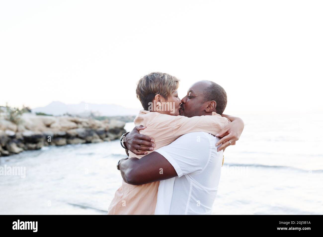 Multiracial couple kissing at the beach.Love lifestyle concept . Stock Photo