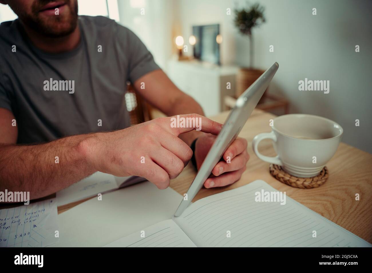 Close up caucasian couple working from home typing on digital tablet Stock Photo