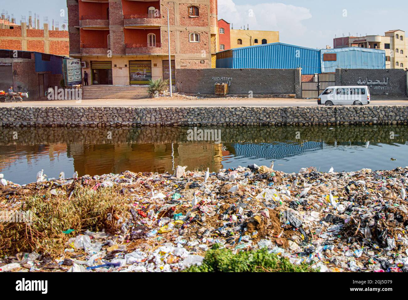 Nile River Expedition, Lower Egypt, Giza (on West Bank of Nile). Streetscene, canal with heaps of trash Stock Photo