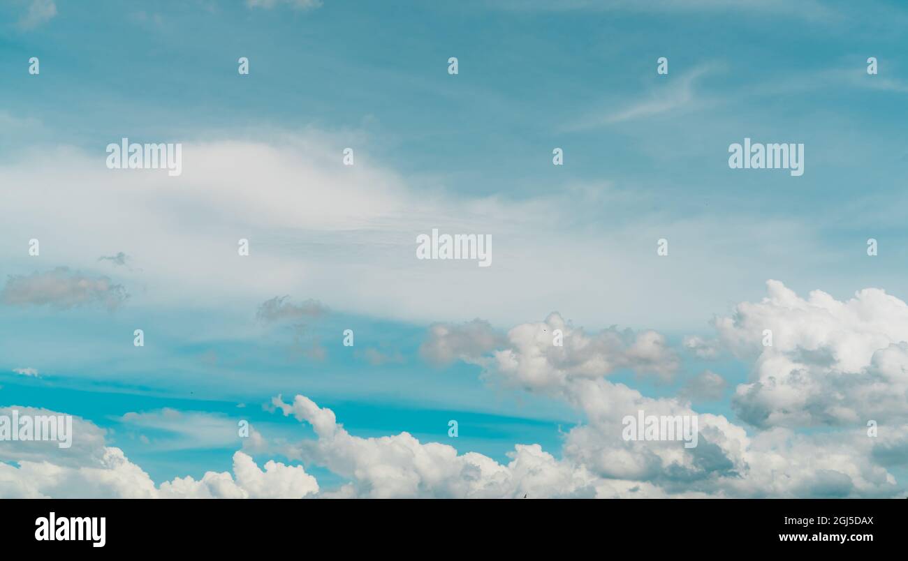 Cloudscape of white stratocumulus clouds on blue sky. Full Frame of white fluffy clouds texture background. Heaven sky with daylight. Beauty in nature Stock Photo