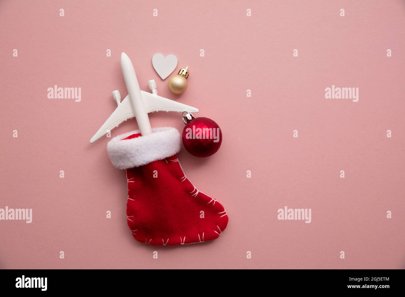 Christmas travel background. model of an airplane with a festive stocking  Stock Photo - Alamy