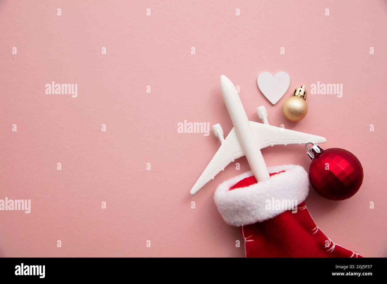 Christmas travel background. model of an airplane with a festive stocking  Stock Photo - Alamy