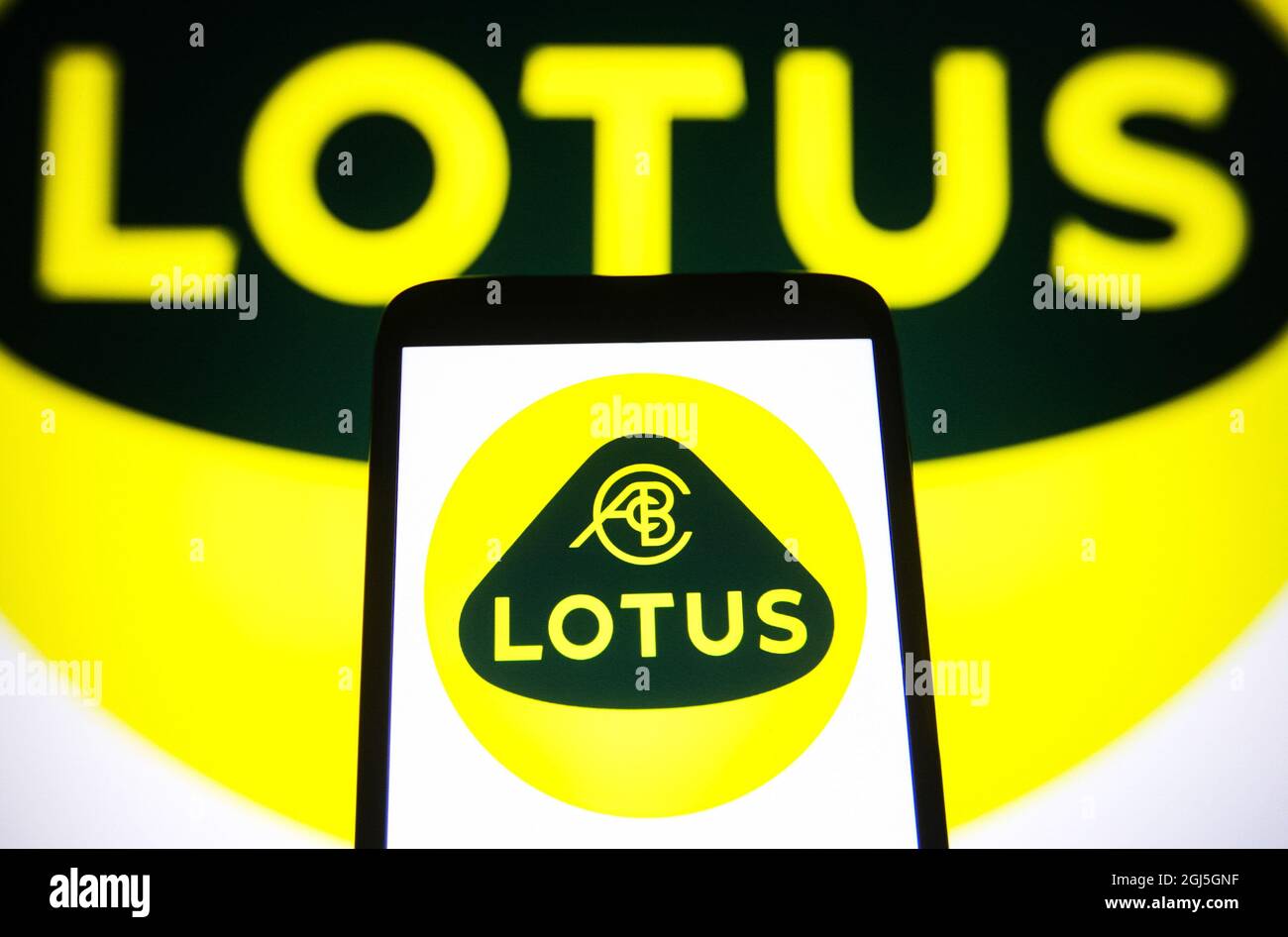 In this photo illustration, Lotus Cars Limited logo of a British automotive company is seen on a smartphone and pc screen. (Photo by Pavlo Gonchar / SOPA Images/Sipa USA) Stock Photo