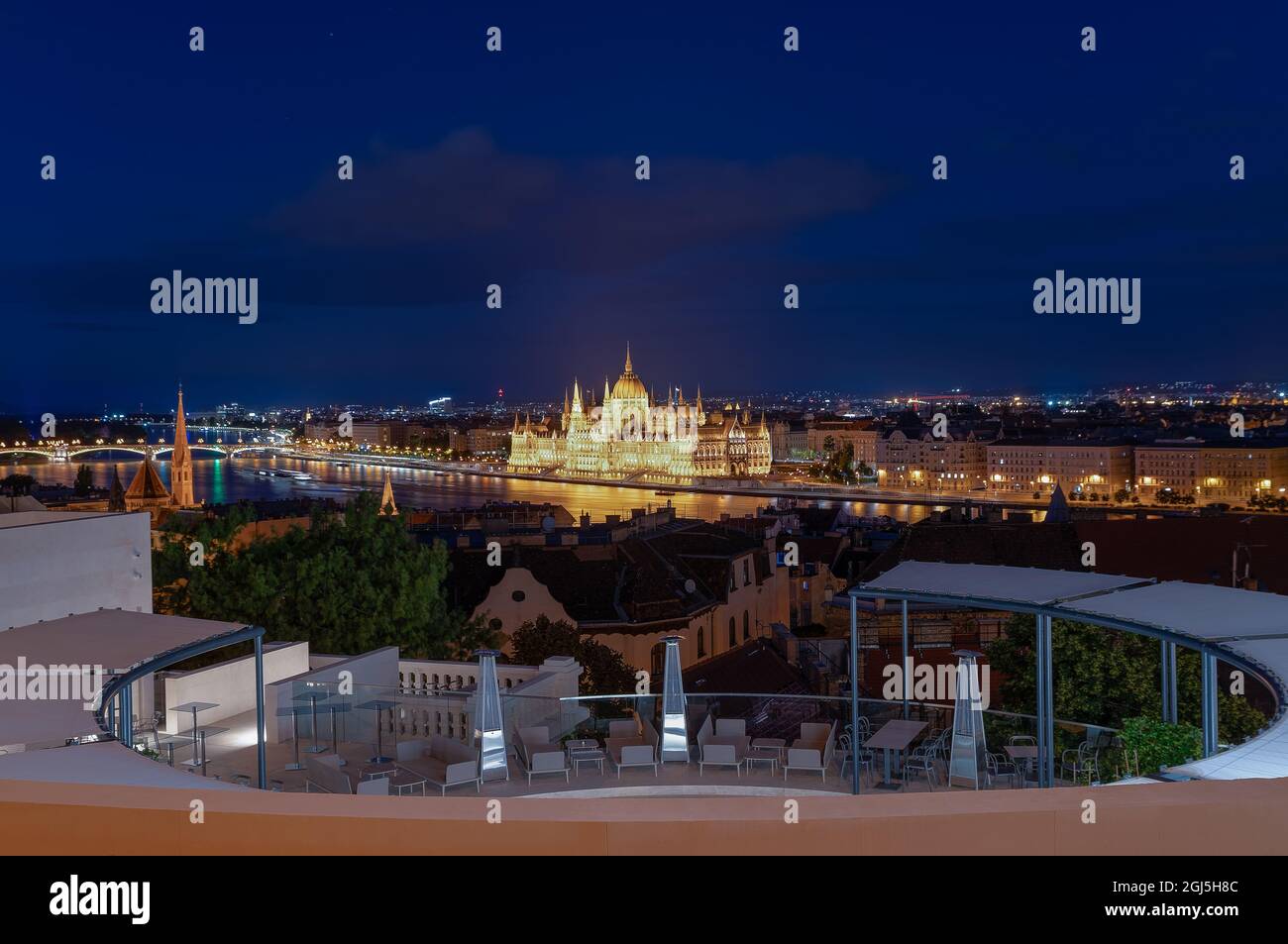 Hungarian Parliament in Budapest Night Cityscape. It has a rooftop terrace in the photo foreground. Amazing night view about Danube river and Budapest Stock Photo