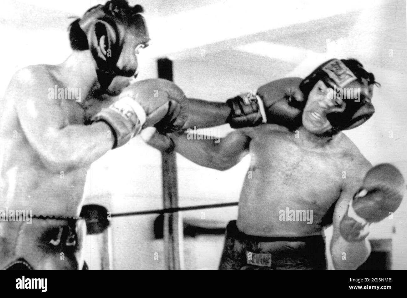 (Muhammad Ali) Cassius Clay World Heavyweight Champion gets a stiff jab on the jaw by Jimmy Ellis 1969 Stock Photo