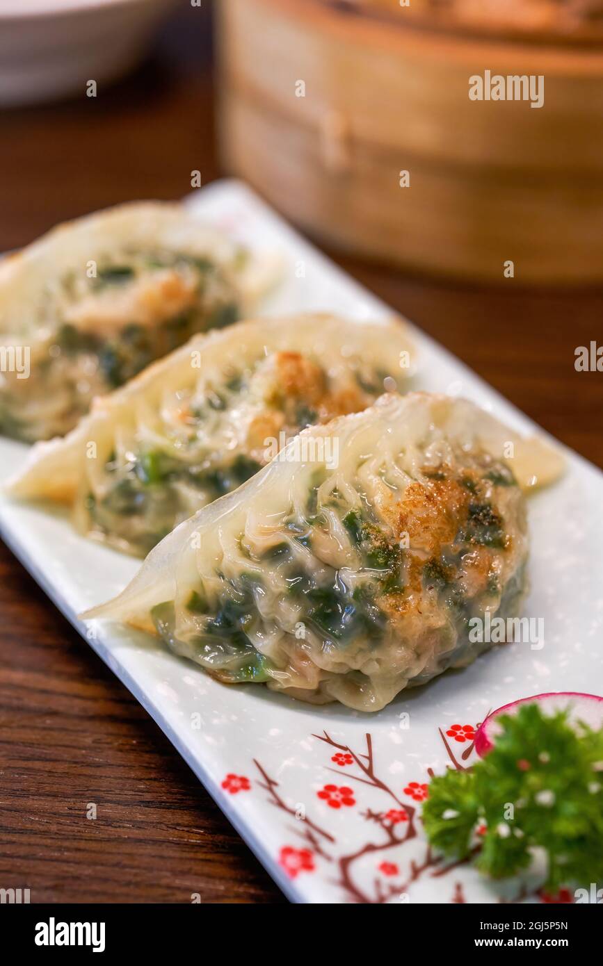 A plate of delicious Chinese fried leek dumplings Stock Photo Alamy