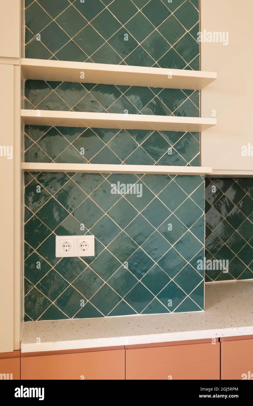Vertical shot of the interiors of a modern house, the kitchen tile ...