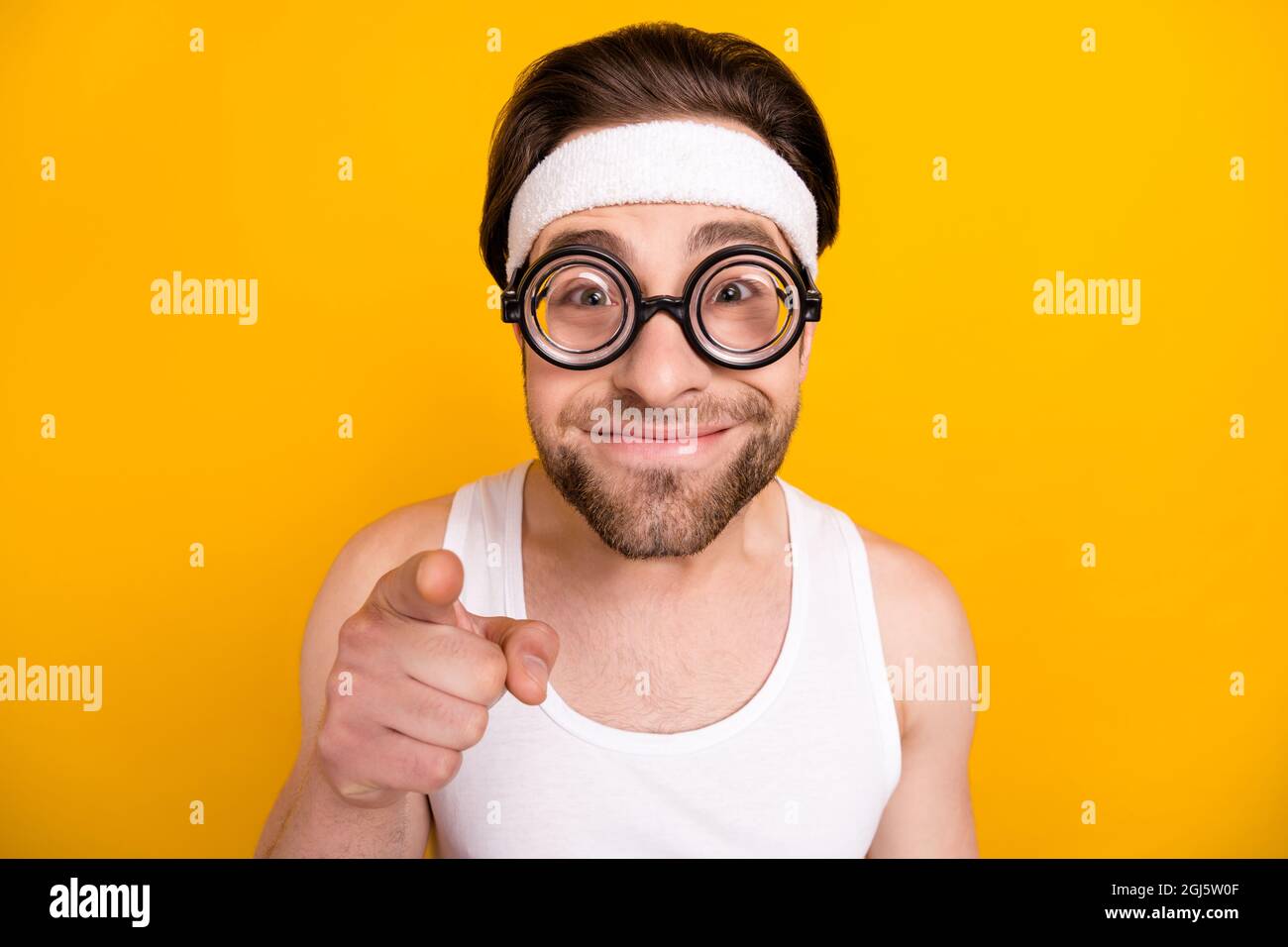Portrait of attractive cheerful funny guy nerd sportsman pointing at you  isolated over bright yellow color background Stock Photo - Alamy