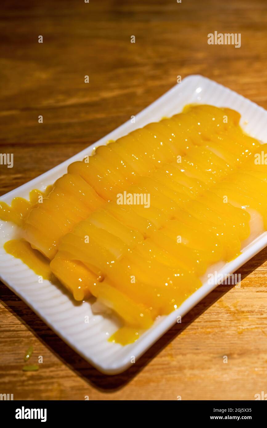 A delicious Thai dessert, mango rice rolls Stock Photo - Alamy