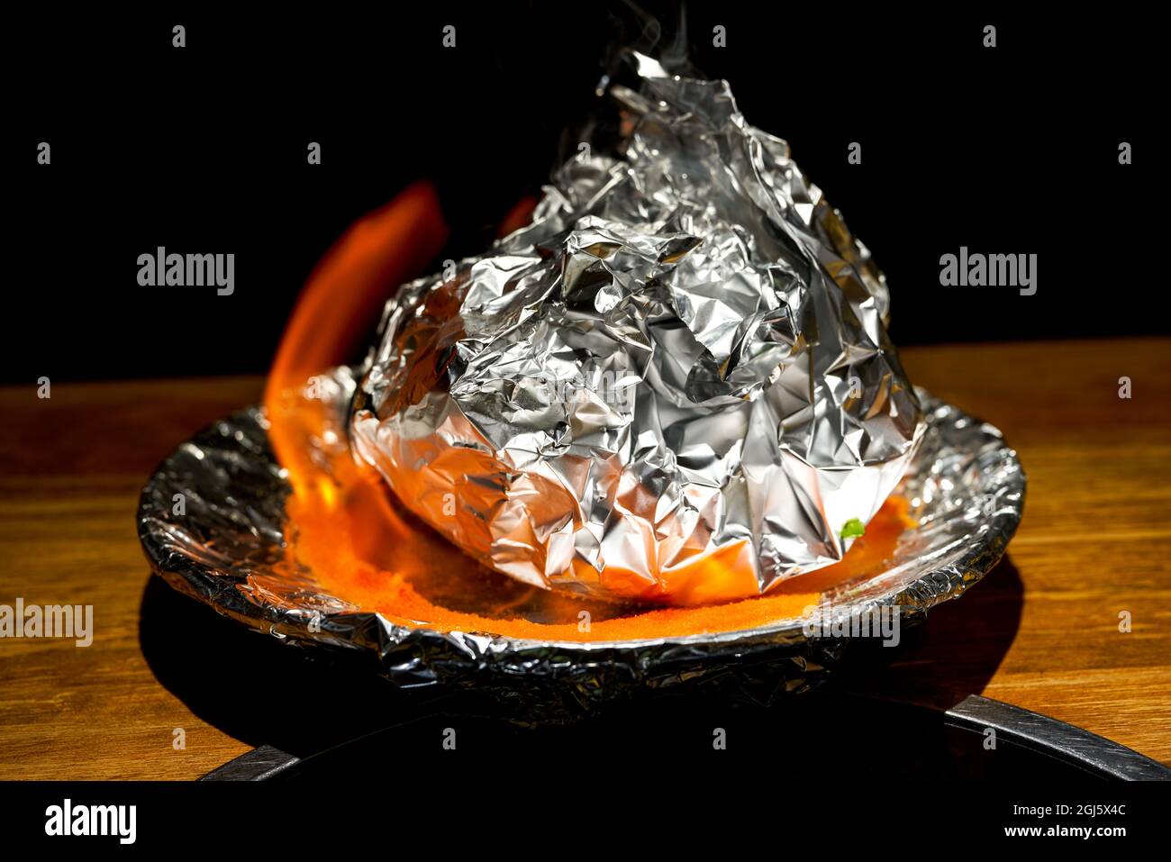 A braised pork ribs in tin foil fired with alcohol Stock Photo