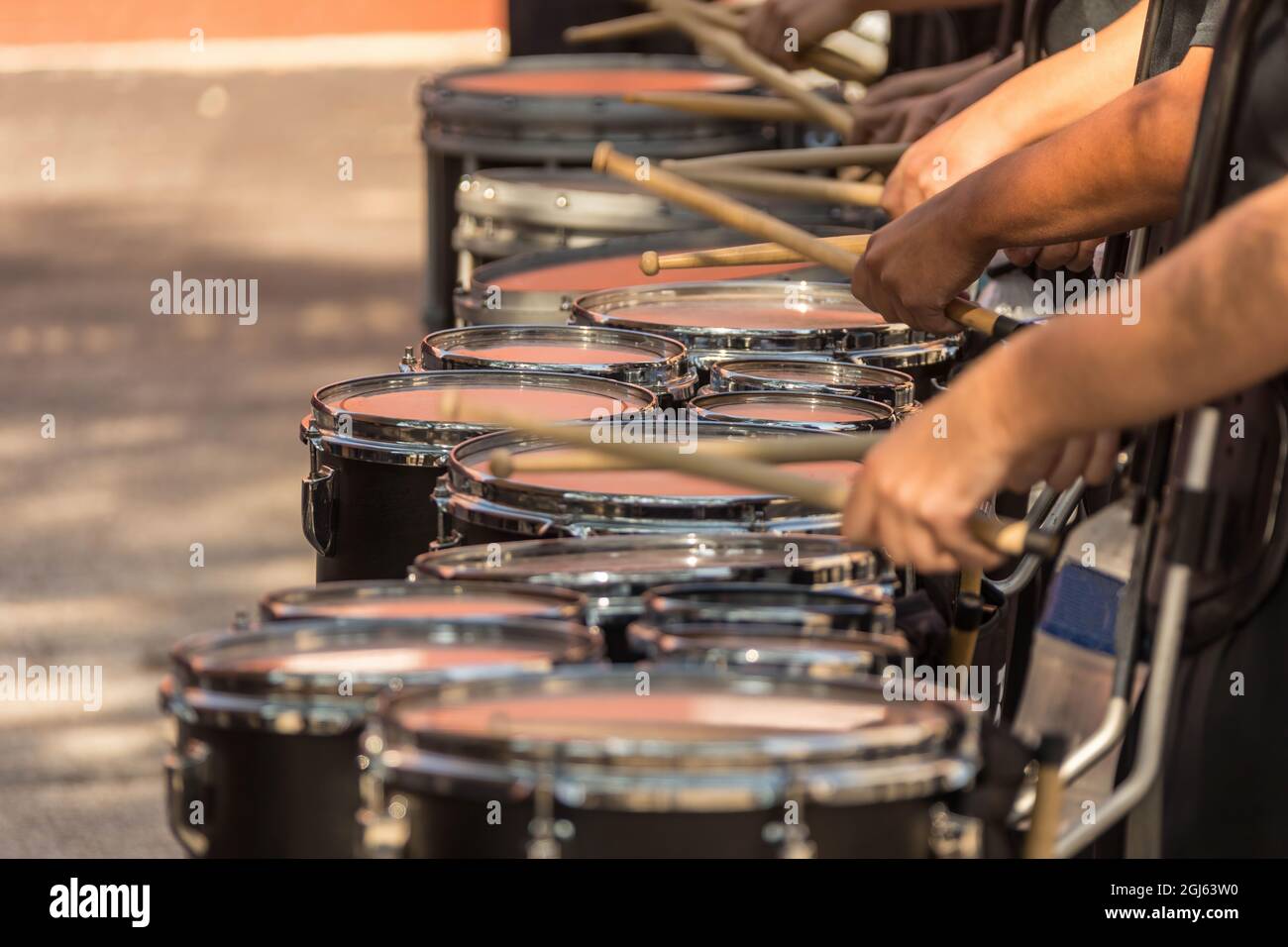 a section of a marching band drum line warming up for a parade Stock Photo