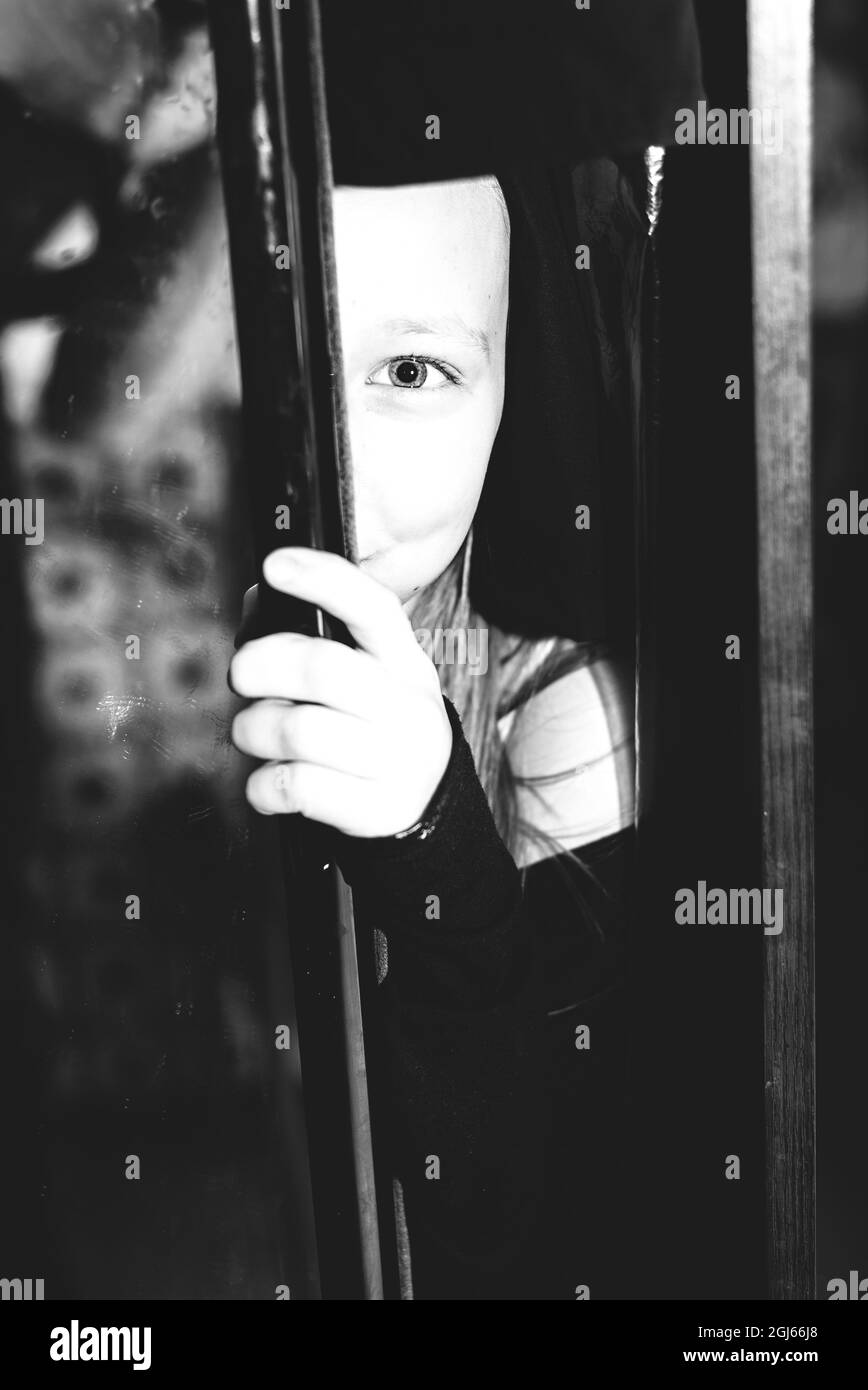 The child hid in the closet. B W photo Stock Photo