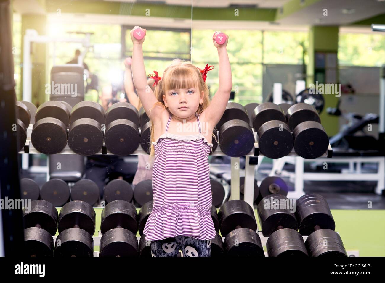 Little girl with dumbbells in the gym Stock Photo - Alamy