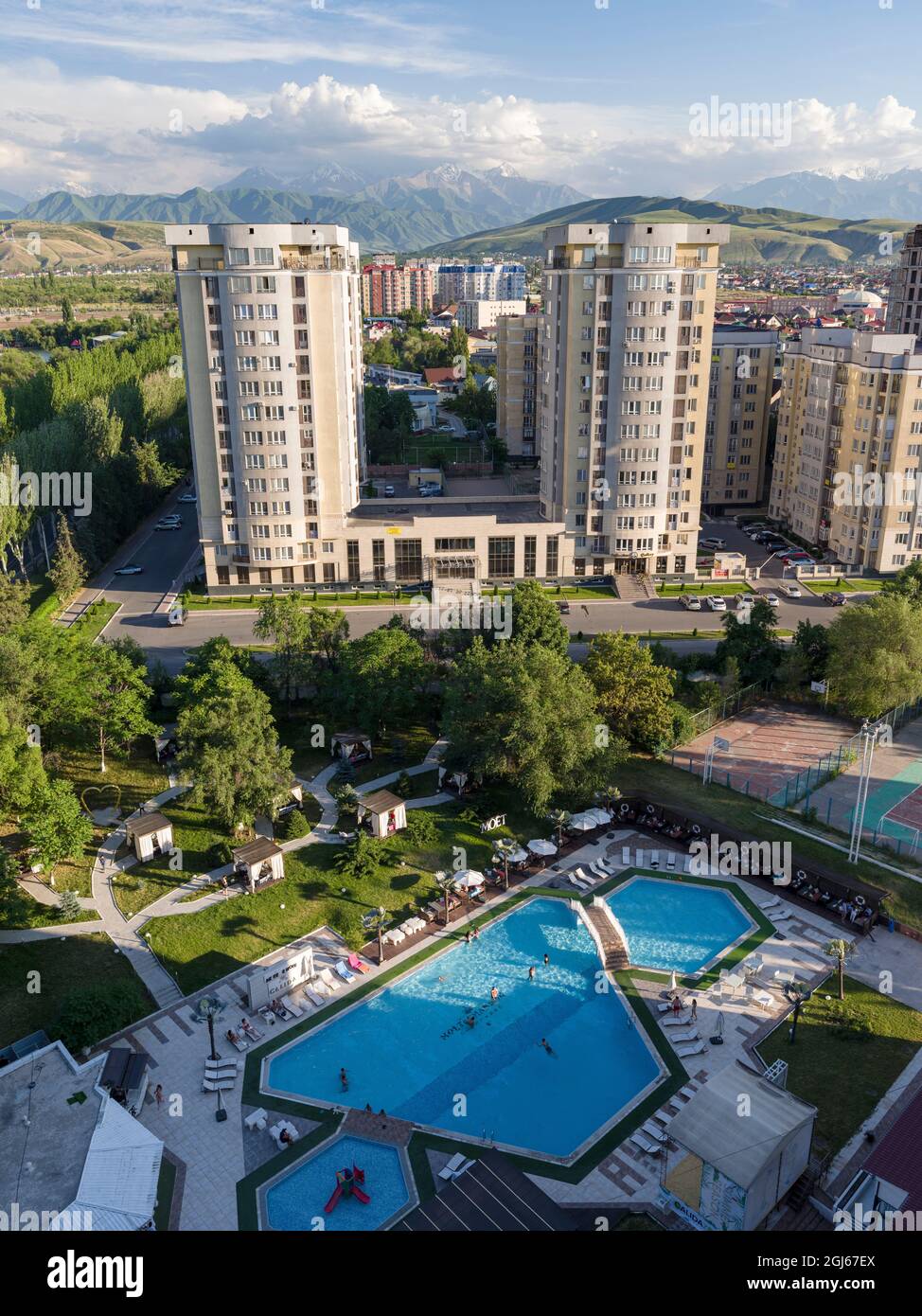 City view with modern high rise buildings, background the mountains of ... - High Rise Buildings In Bishkek
