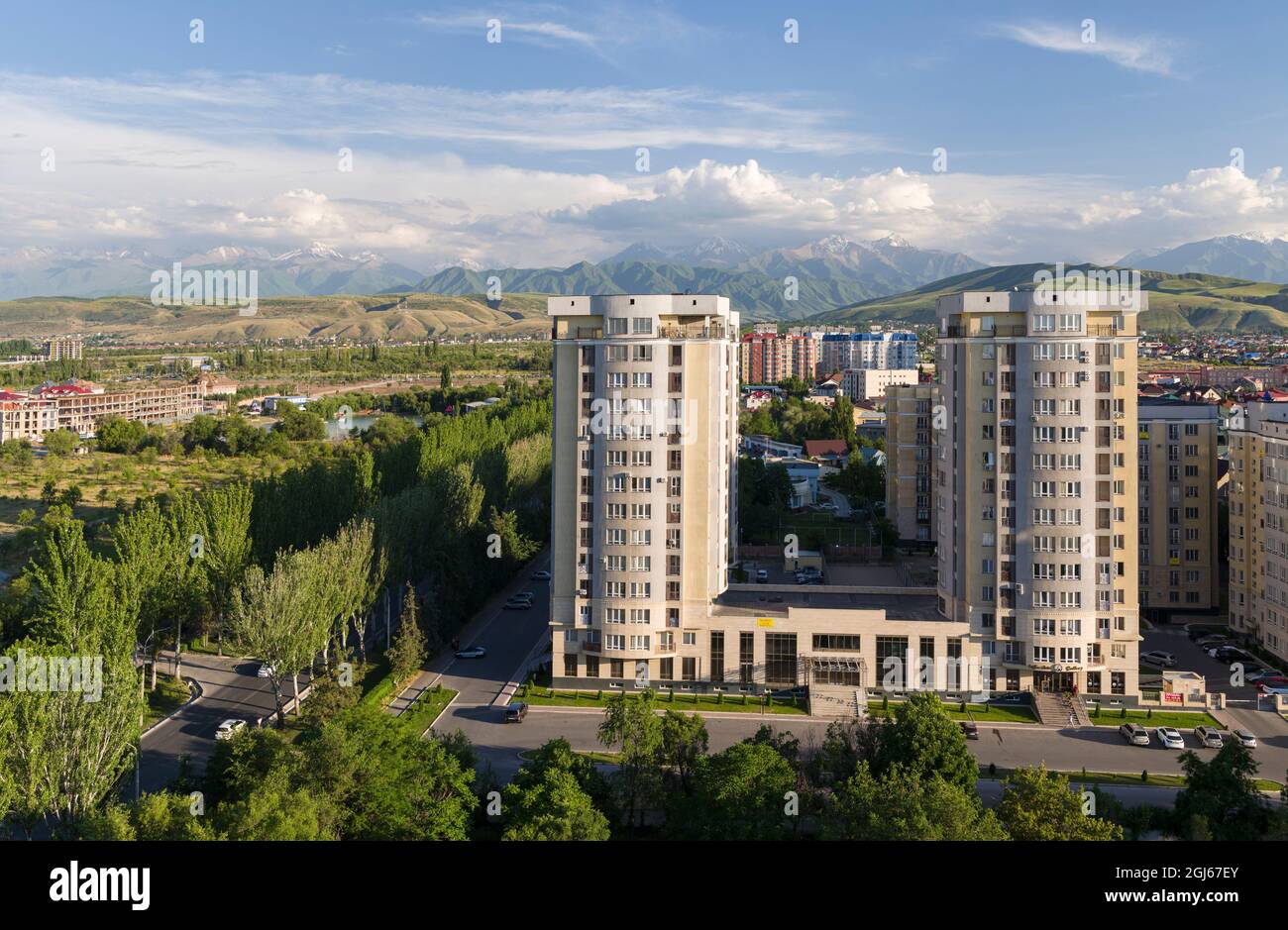 City view with modern high rise buildings, background the mountains of Alatau and Ala Artscha National Park The capital Bishkek located in the foothil Stock Photo