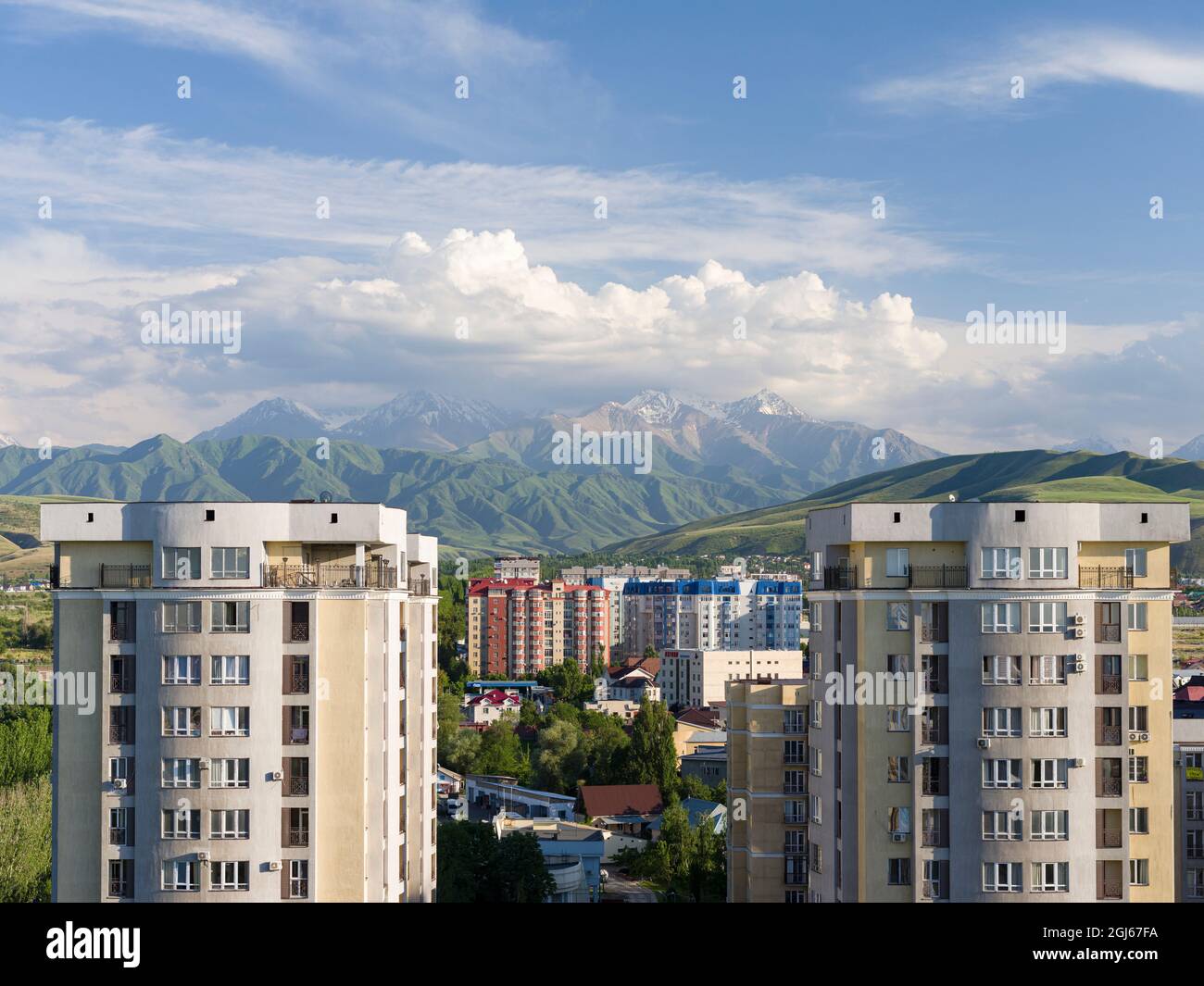 City view with modern high rise buildings, background the mountains of ...
