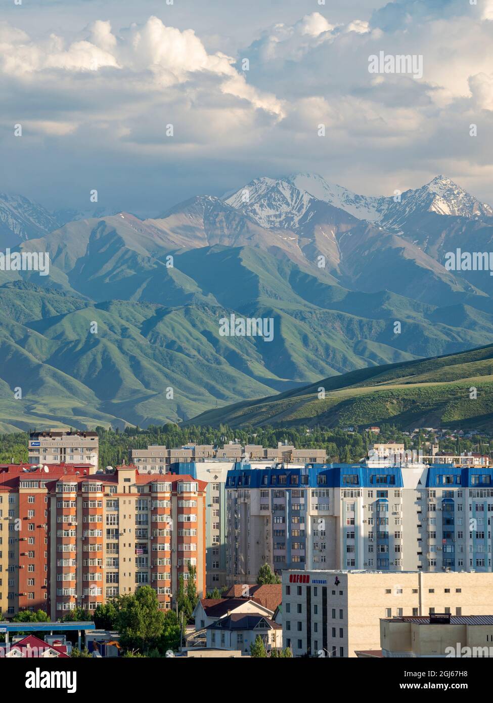 Picture of City view with modern high rise buildings, background the mountains of ...