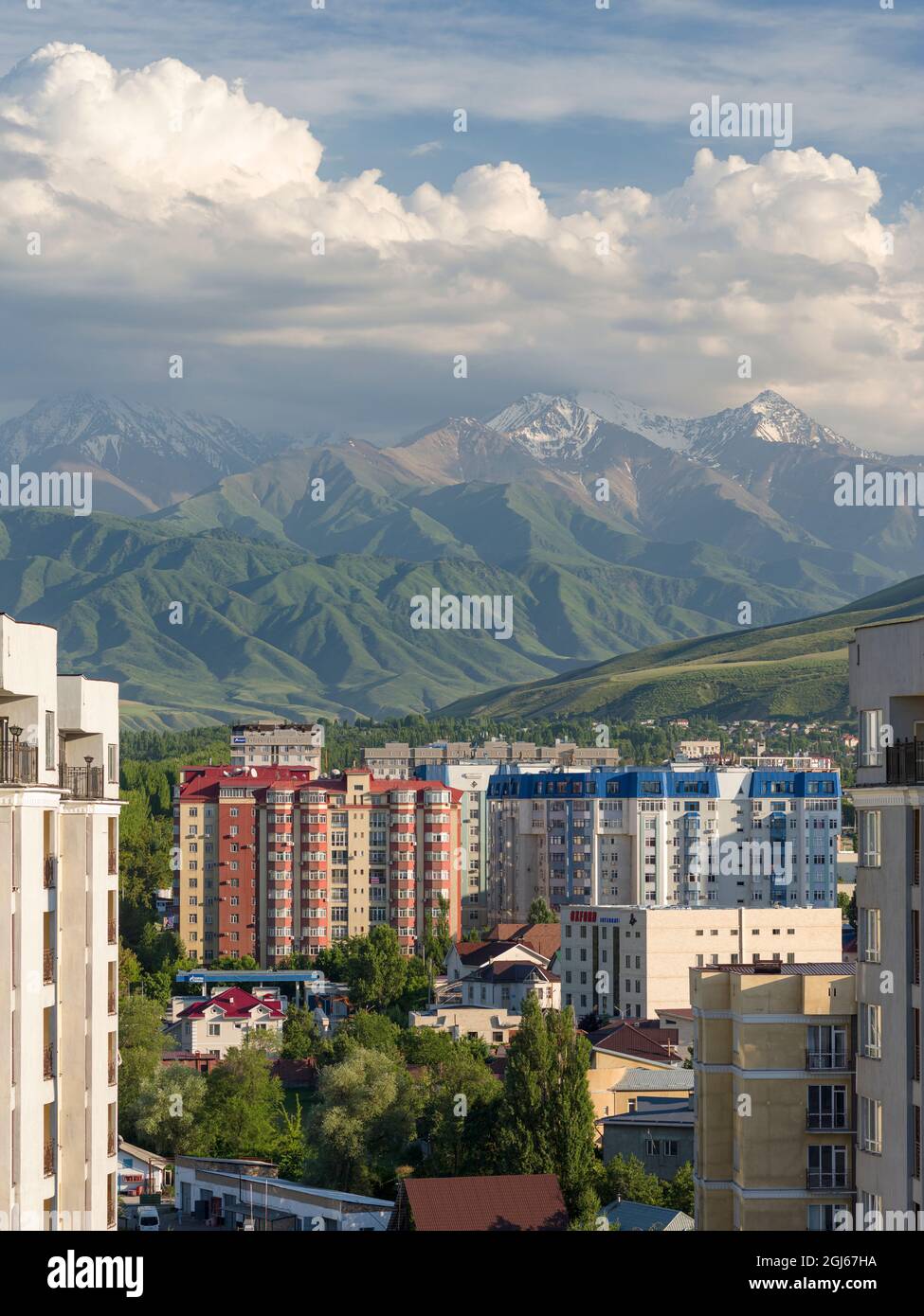 Picture of City view with modern high rise buildings, background the mountains of ...
