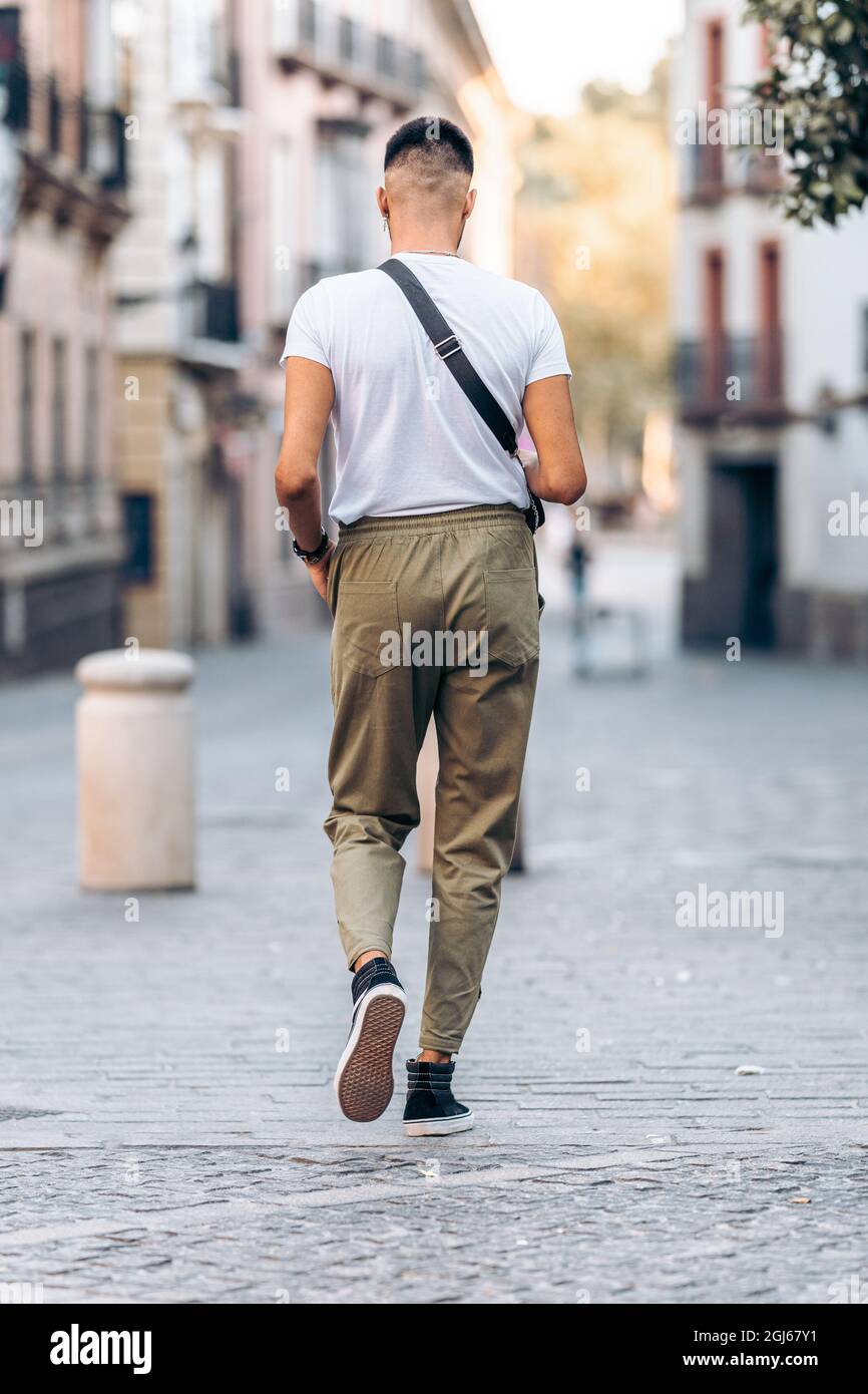 Man walking down the street dressed in casual clothing Stock Photo