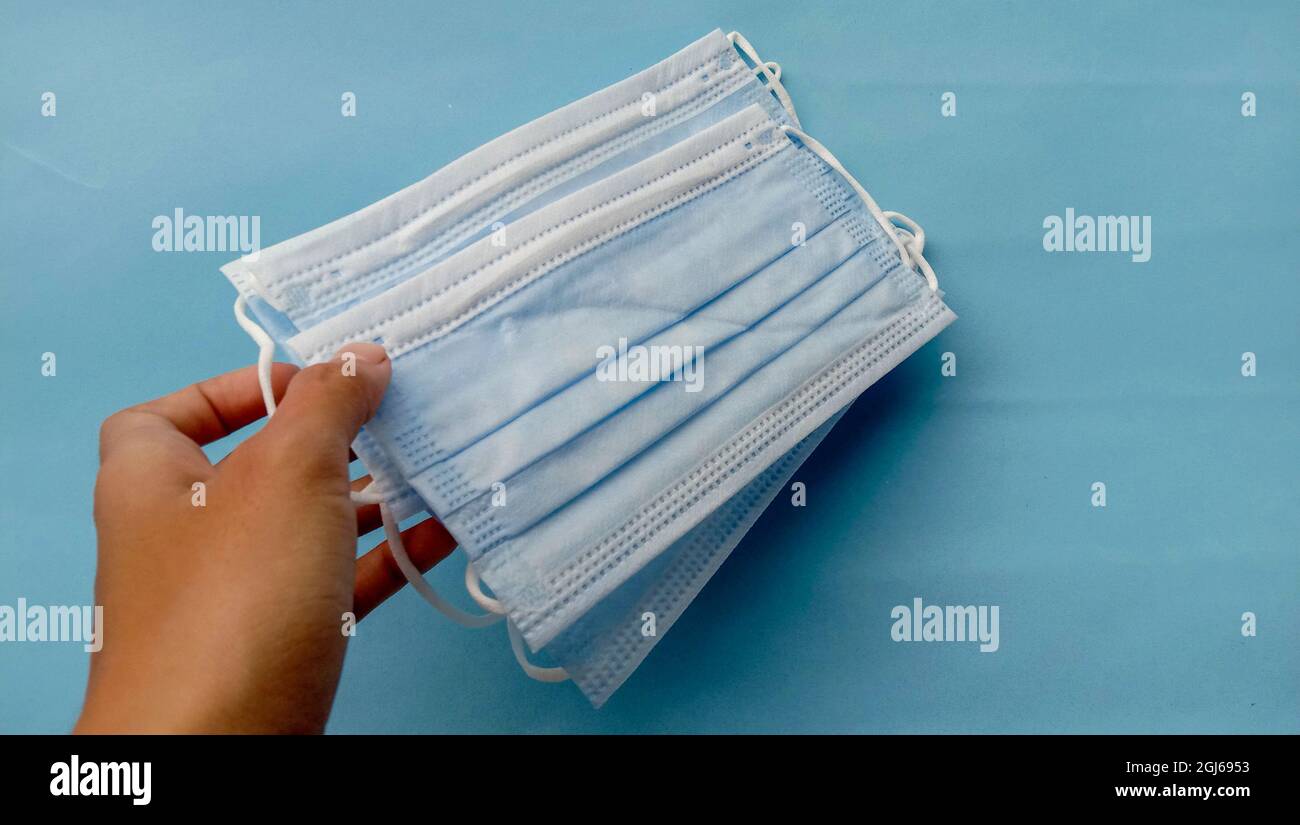 Medical mask on a light blue background Stock Photo - Alamy