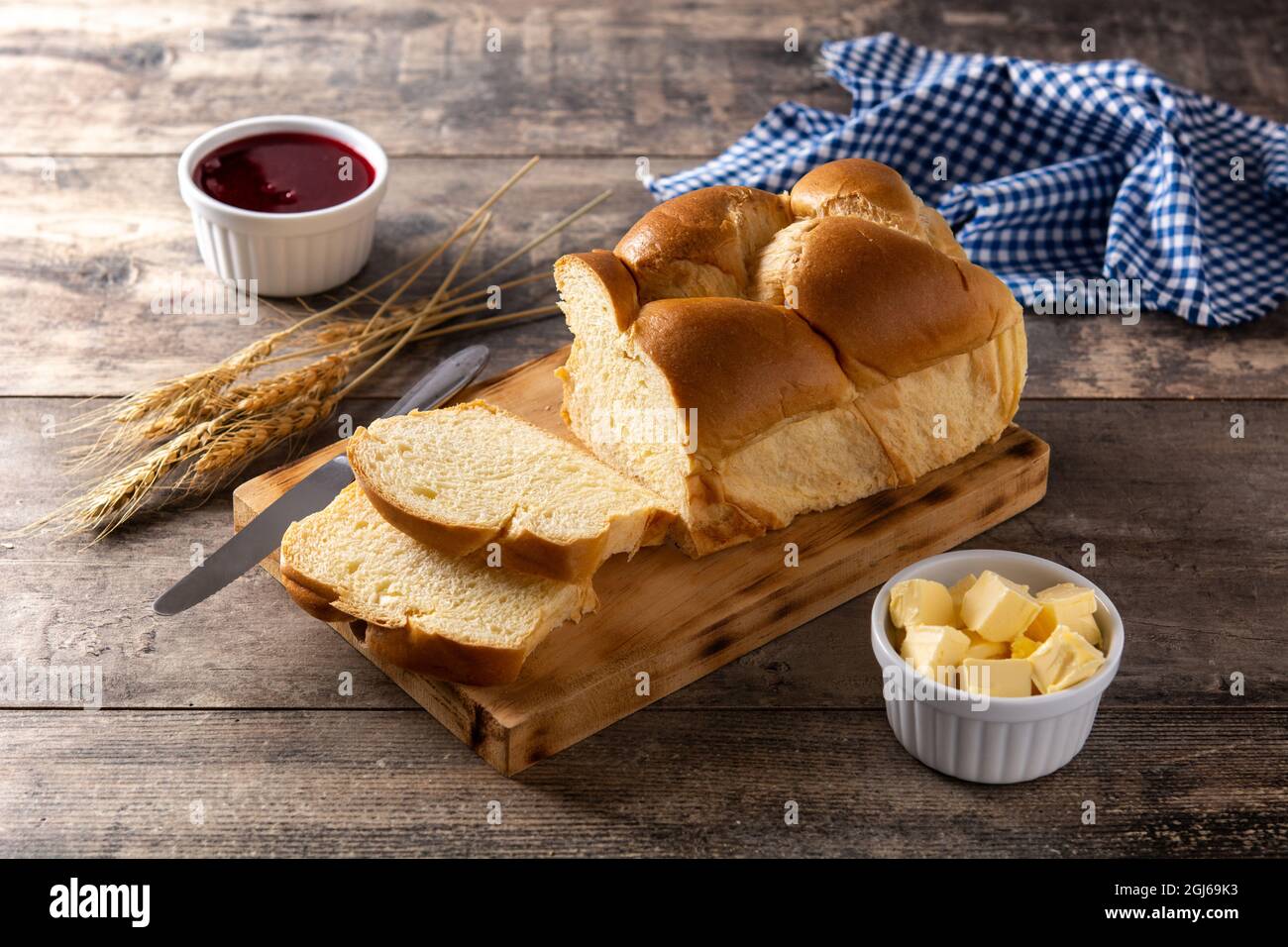 Braided egg bread on wooden table Stock Photo