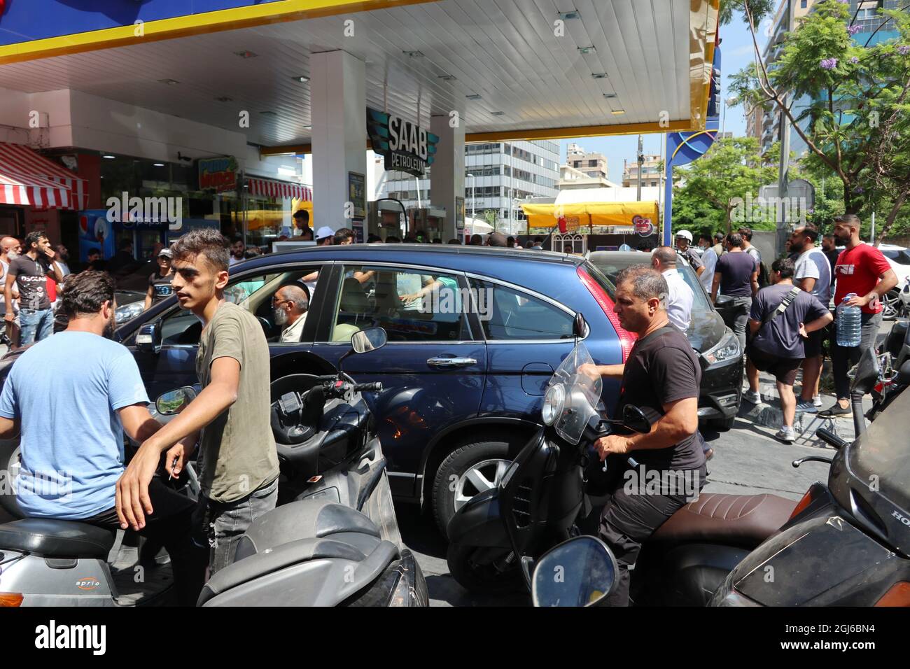 People crowd a gas station in Hamra street, Beirut, Lebanon, on