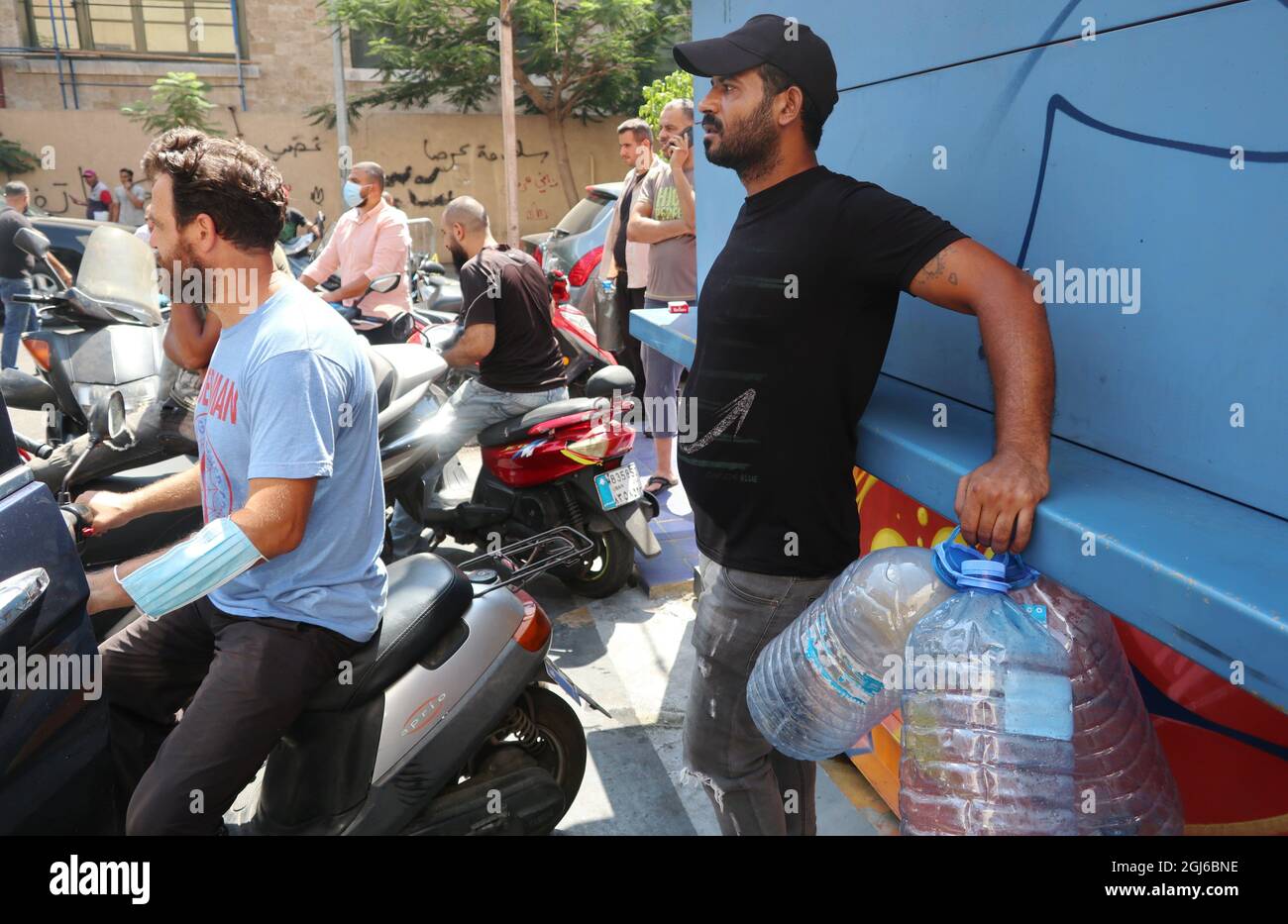 People wait to refill at a gas station in Hamra street, Beirut, Lebanon