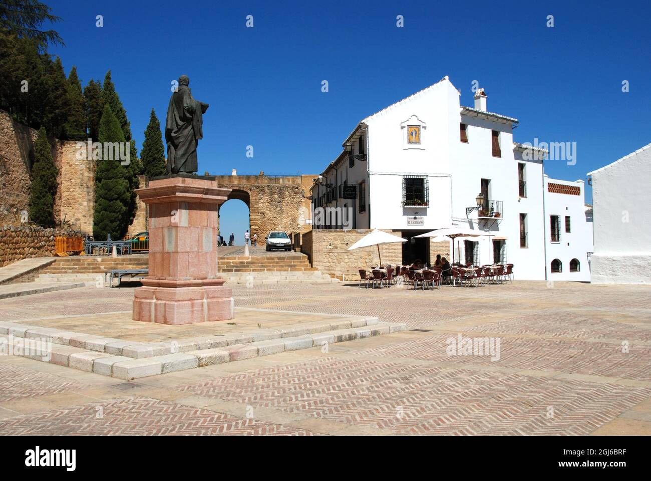 Statue of Pedro Espinosa in the Plaza de Santa Maria with a pavement cafe  and the giants arch to the rear, Antequera, Spain Stock Photo - Alamy