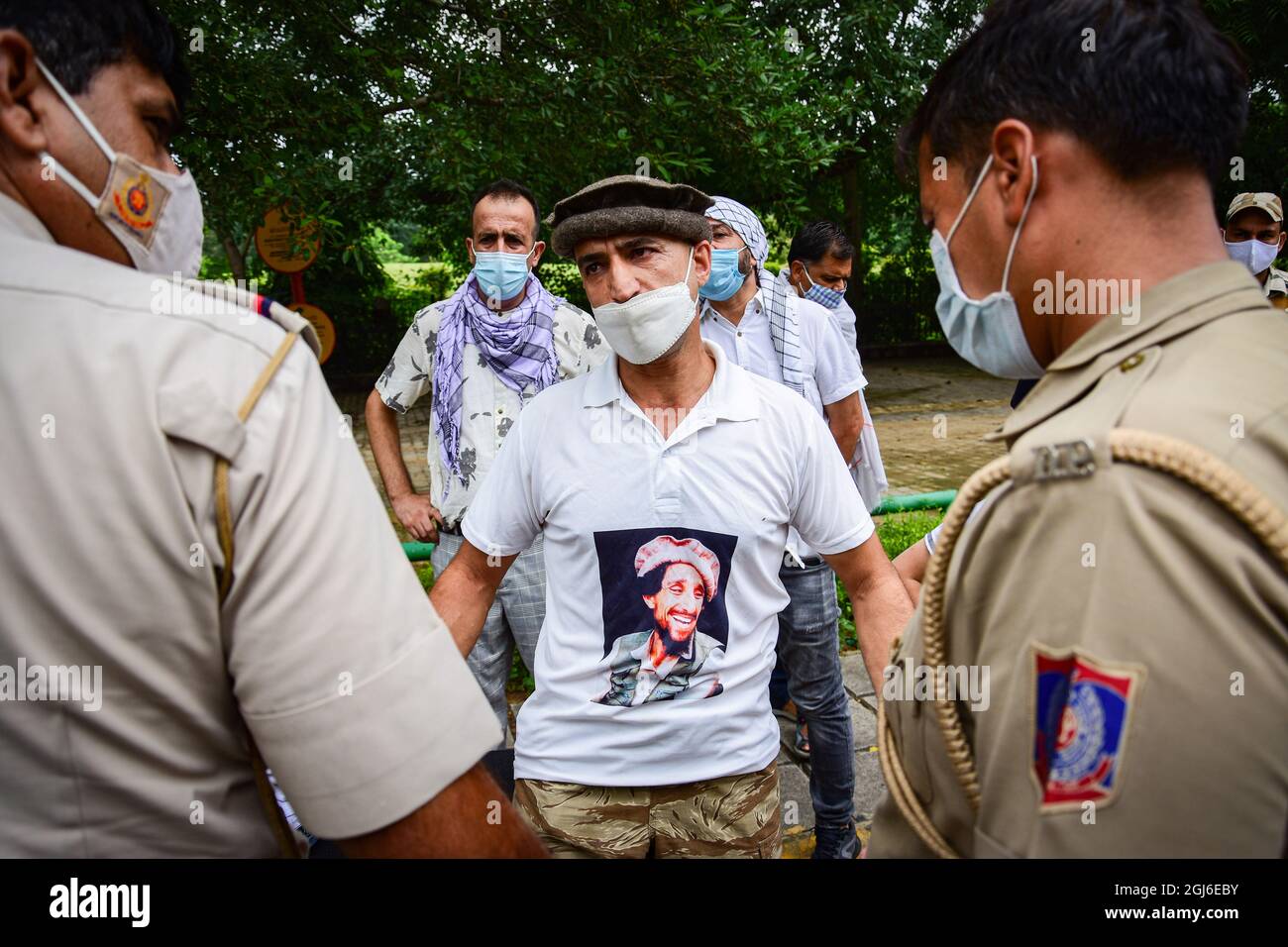New Delhi, India. 09th Sep, 2021. An Afghan refugee wearing a t-shirt with a picture of the former slain Mujahideen commander Ahmad Shah Massoud, speaks to a policeman after they were denied permission to hold a protest near the Pakistan embassy in New Delhi. Credit: SOPA Images Limited/Alamy Live News Stock Photo