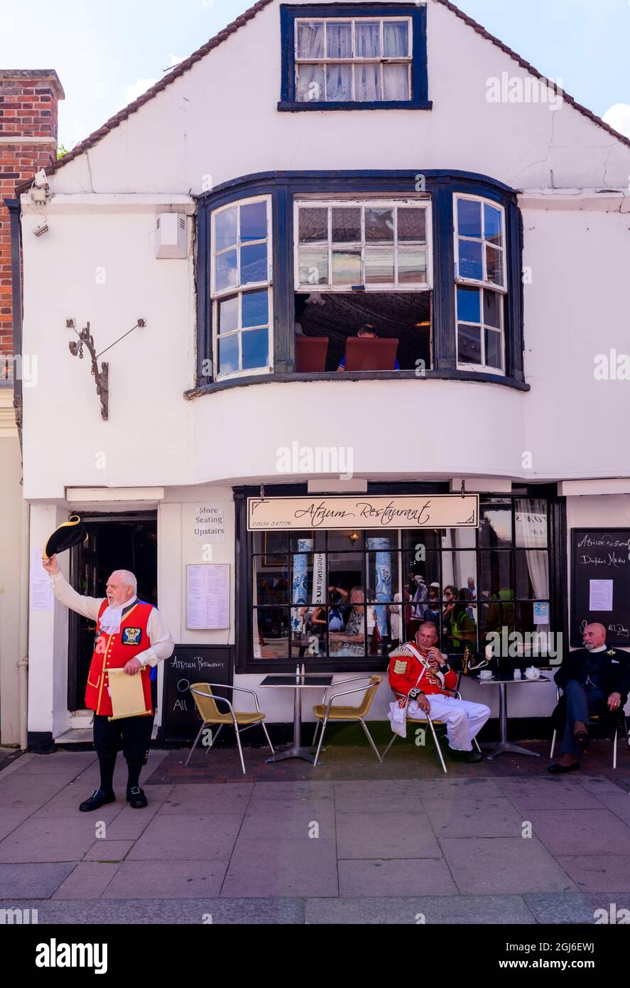 town cryer outside the Atrium Restaurant Rochester during the Dickens festival Kent UK Stock Photo