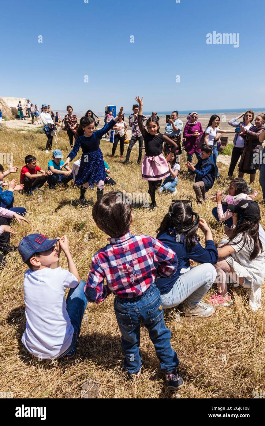 Azerbaijan, Qobustan. Qobustan Petroglyph Reserve, Petroglyph Trail, children dancing traditional dance. Stock Photo
