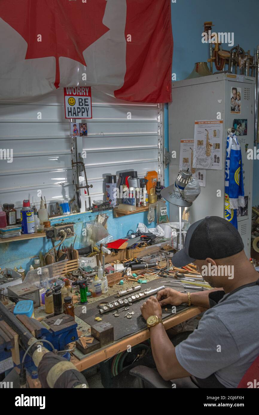 Craftsman fixing a flute in the wind instrument repair shop at the Central  National School of Art in Habana, Cuba Stock Photo - Alamy