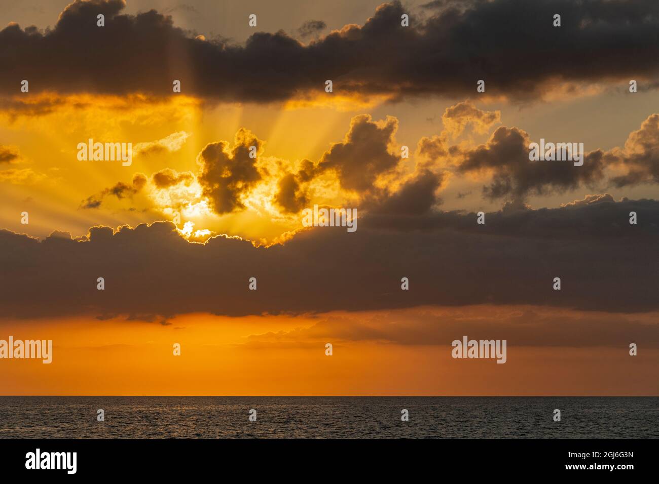 Sunset in clouds over ocean La Boca, Cuba Stock Photo