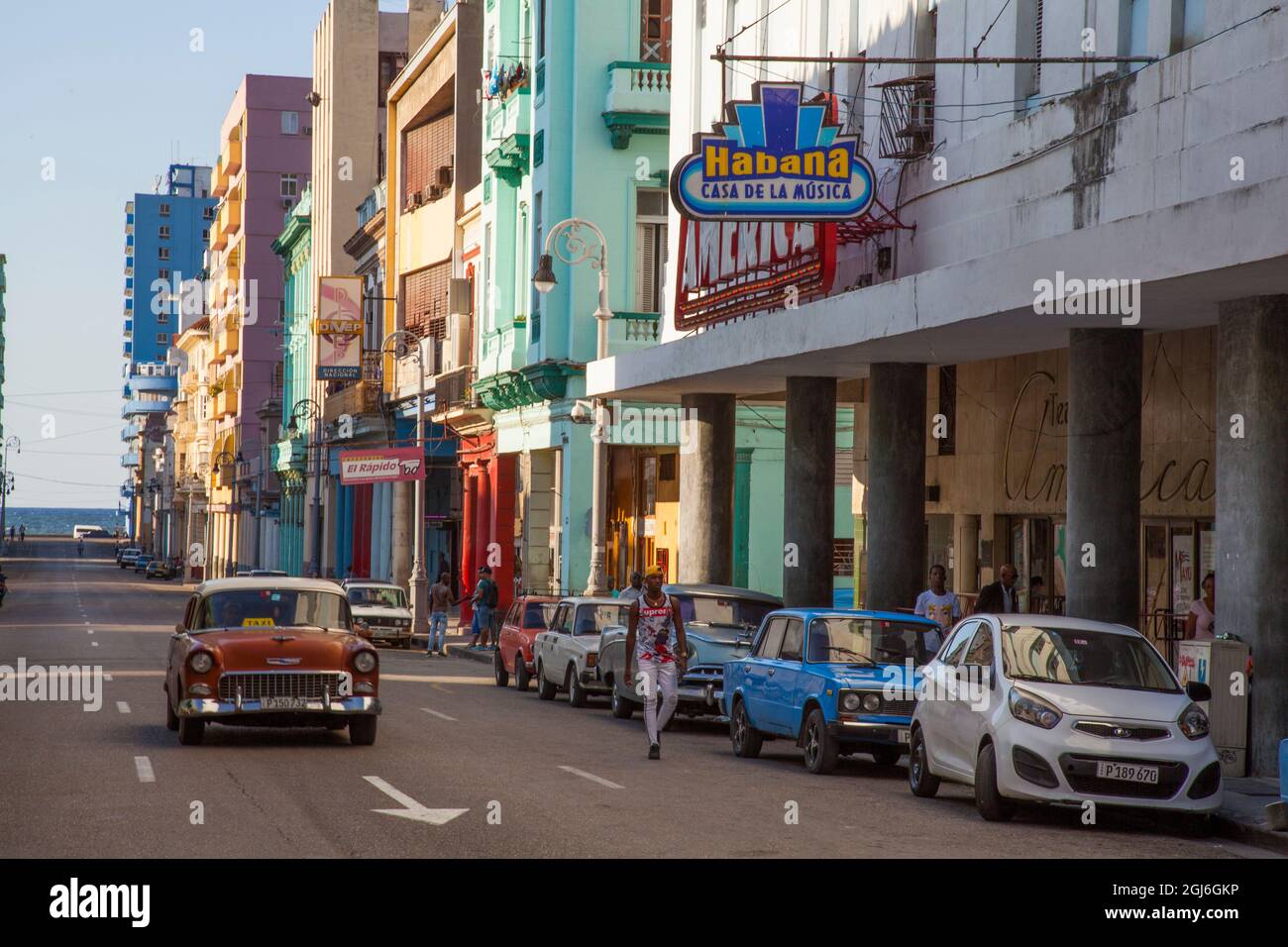 Classic cars driving down street in Havana, Cuba. Stock Photo