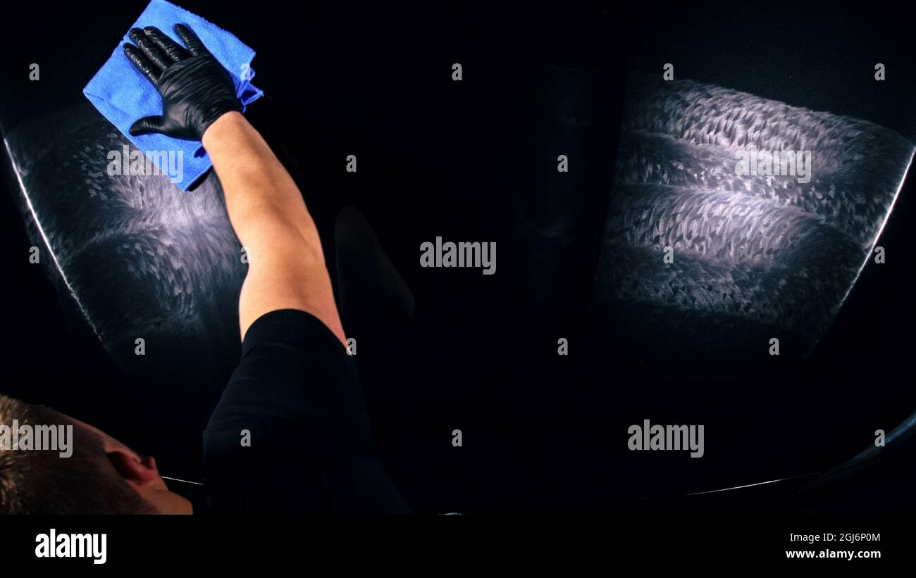 Using rag in palm of your hand, drops are removed from the car. Drop ...