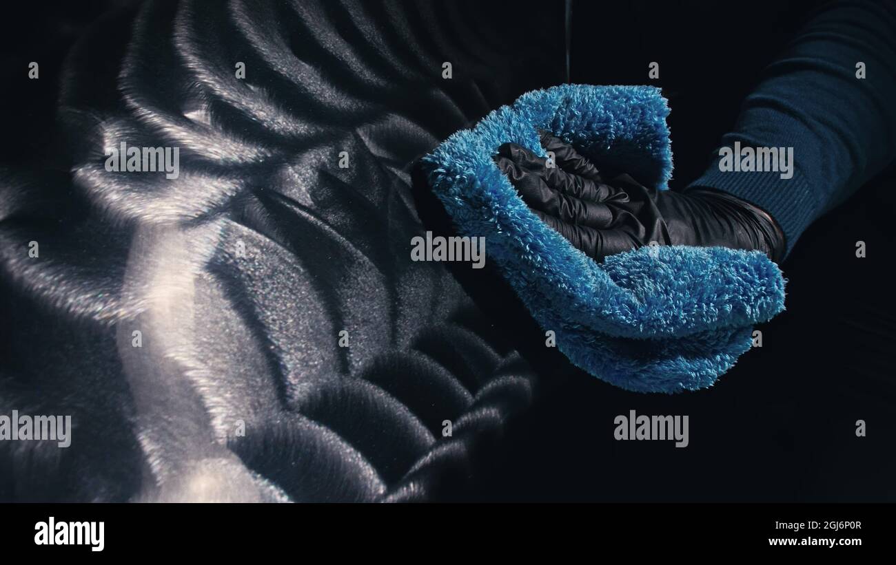 Using rag in palm of your hand, finish liquid car polish are removed