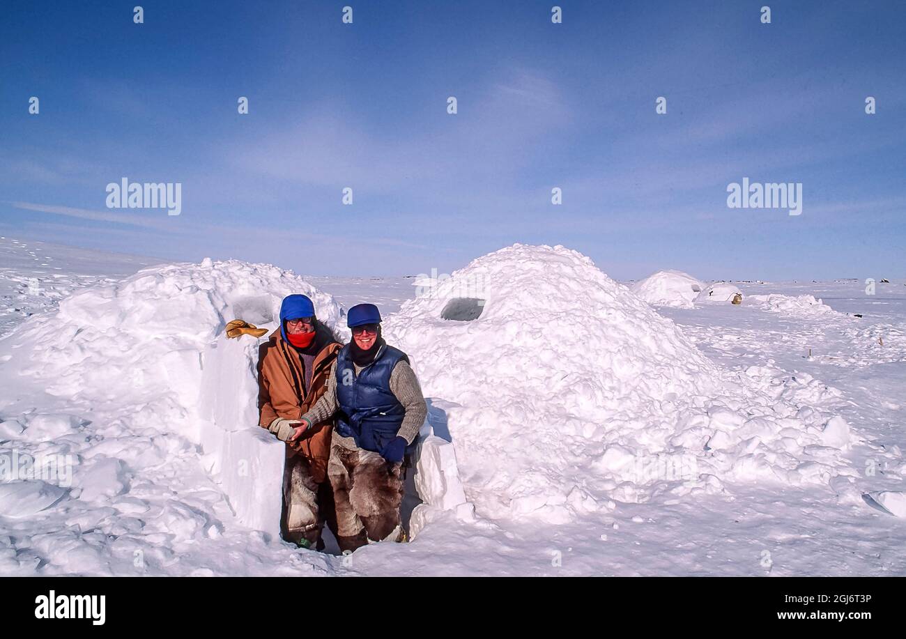 Baker Lake, Nunavut, Canada. Man and woman outside Inuit built igloo ...