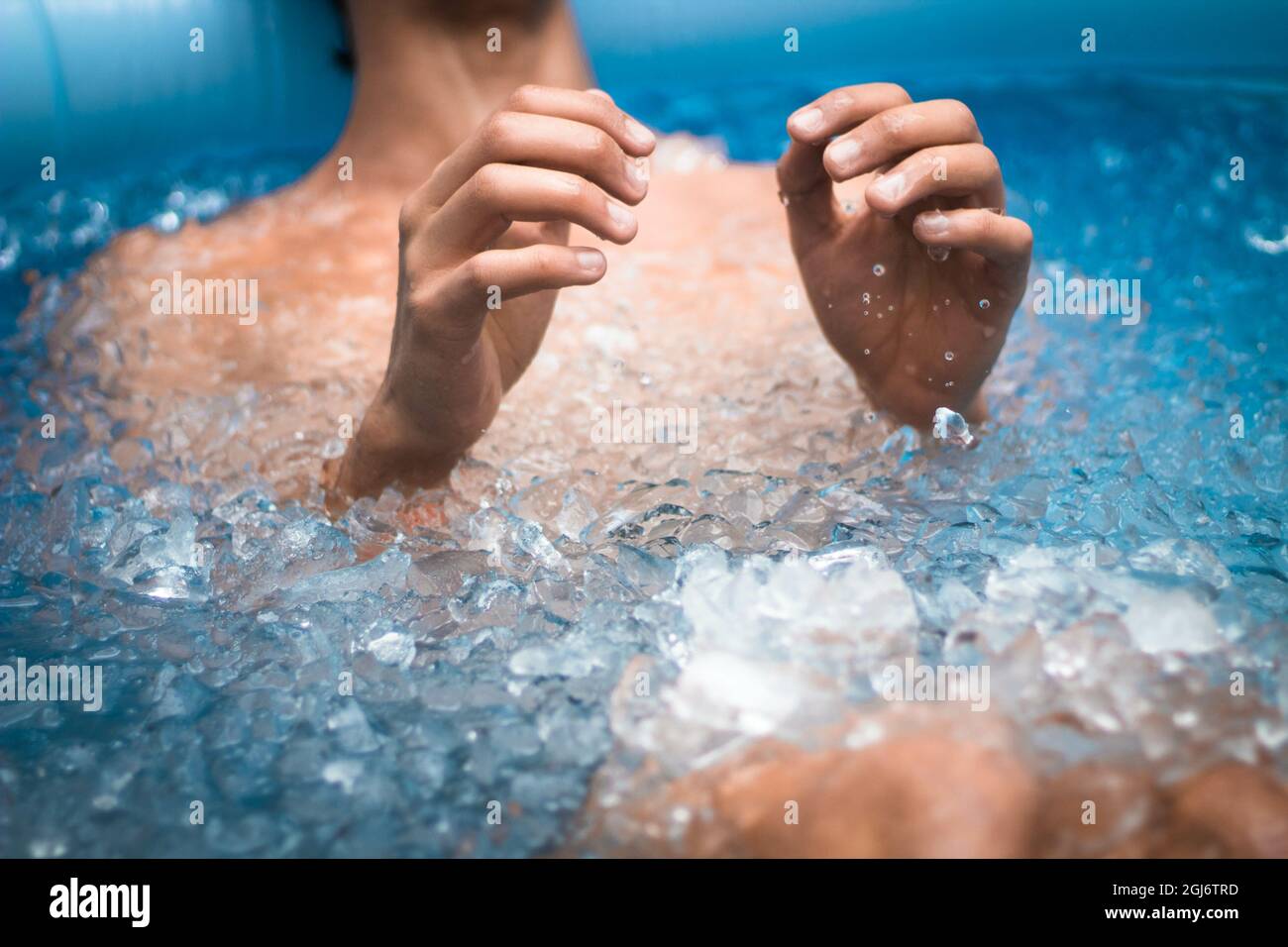 Close up shot on a man body staying in iced water of pool for healthcare Stock Photo