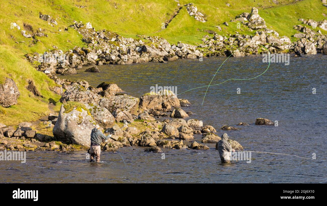 Europe, Faroe Islands. View of fly fishermen casting on the island of Streymoy Stock Photo