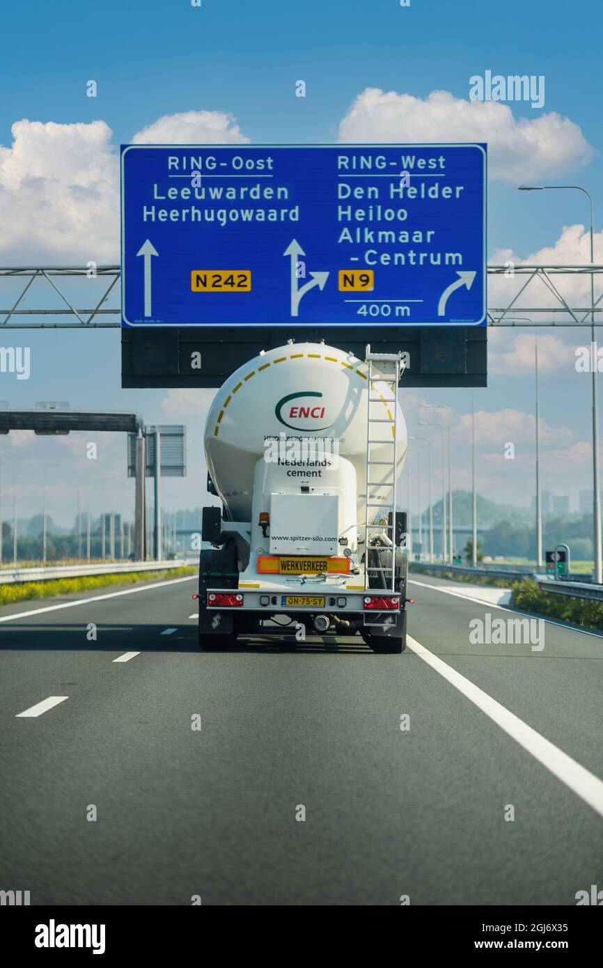 rear view of Cargo truck mixer Actros with sister containing cement from the Enci Heidelberg Cement Group Stock Photo